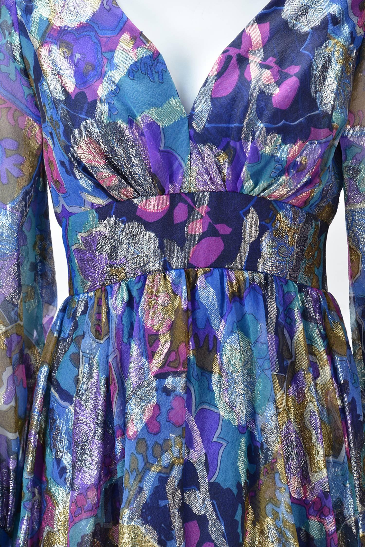 Gorgeous and fun 1970's Oscar de la Renta abstract floral, iridescent, metallic maxi dress is great for any Holiday party.  This dress has hues of purple & blue with gold metallic threads in a blossom motif.

Empire waist dress has wide waist band