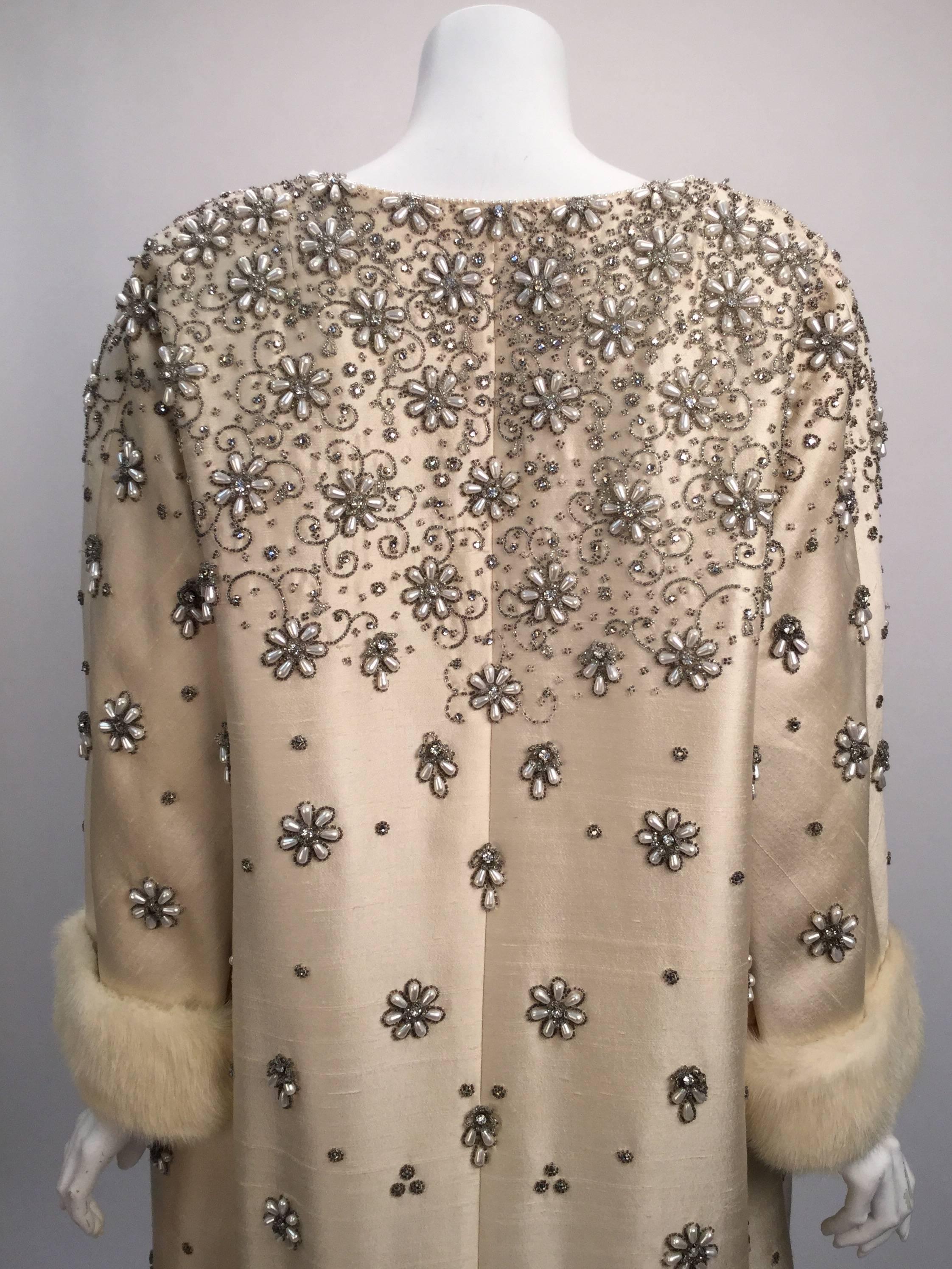 Unbelievable 1960's Victoria Royal Ltd. ivory embellished dress ensemble!

Dress is artistically detailed in rhinestones and pearlized beads in the form of flowers.  The top of this sleeveless dress features heavier beading and floral patterns at