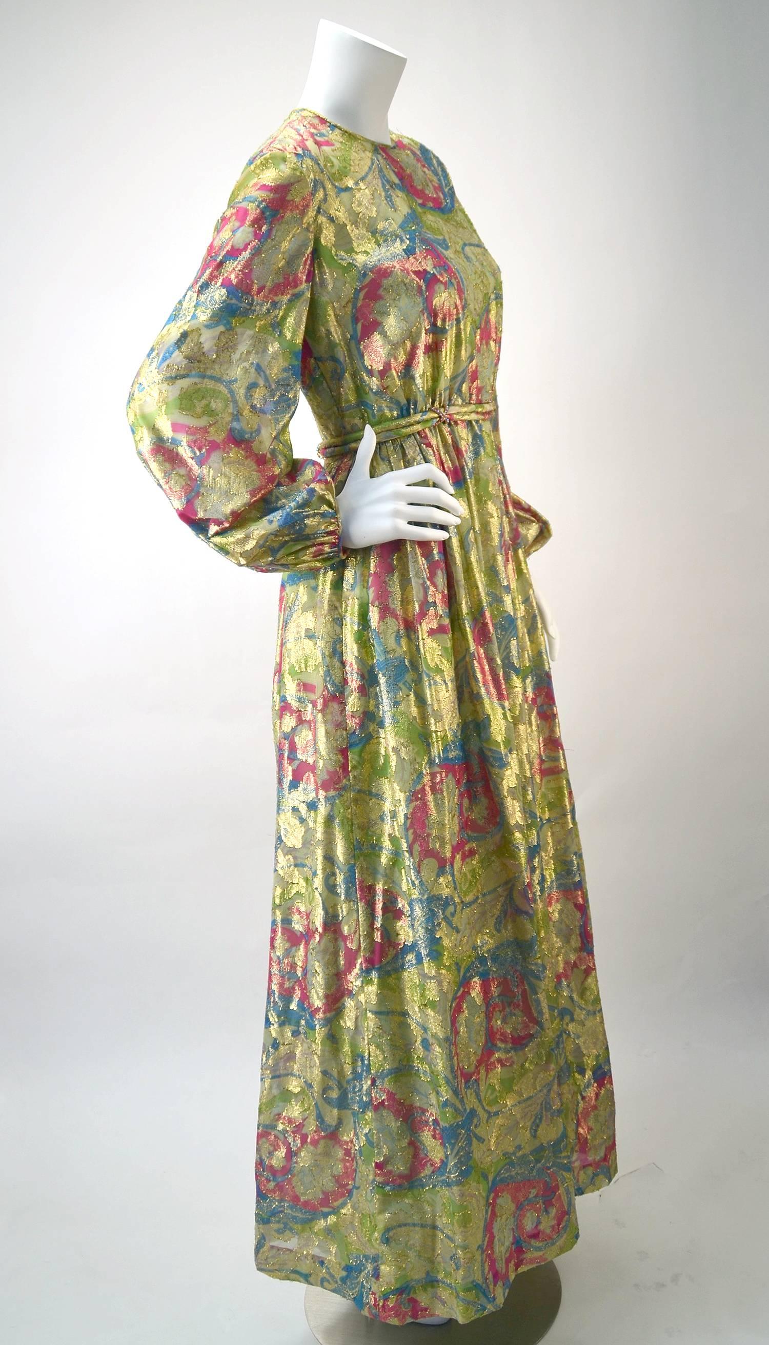 Both fun and stunning vintage Bonwit Teller metallic floral evening dress is great for any Spring Events you might have in the future as well as any time of year!

The dress is full length with wonderful full length sheer balloon sleeves and can