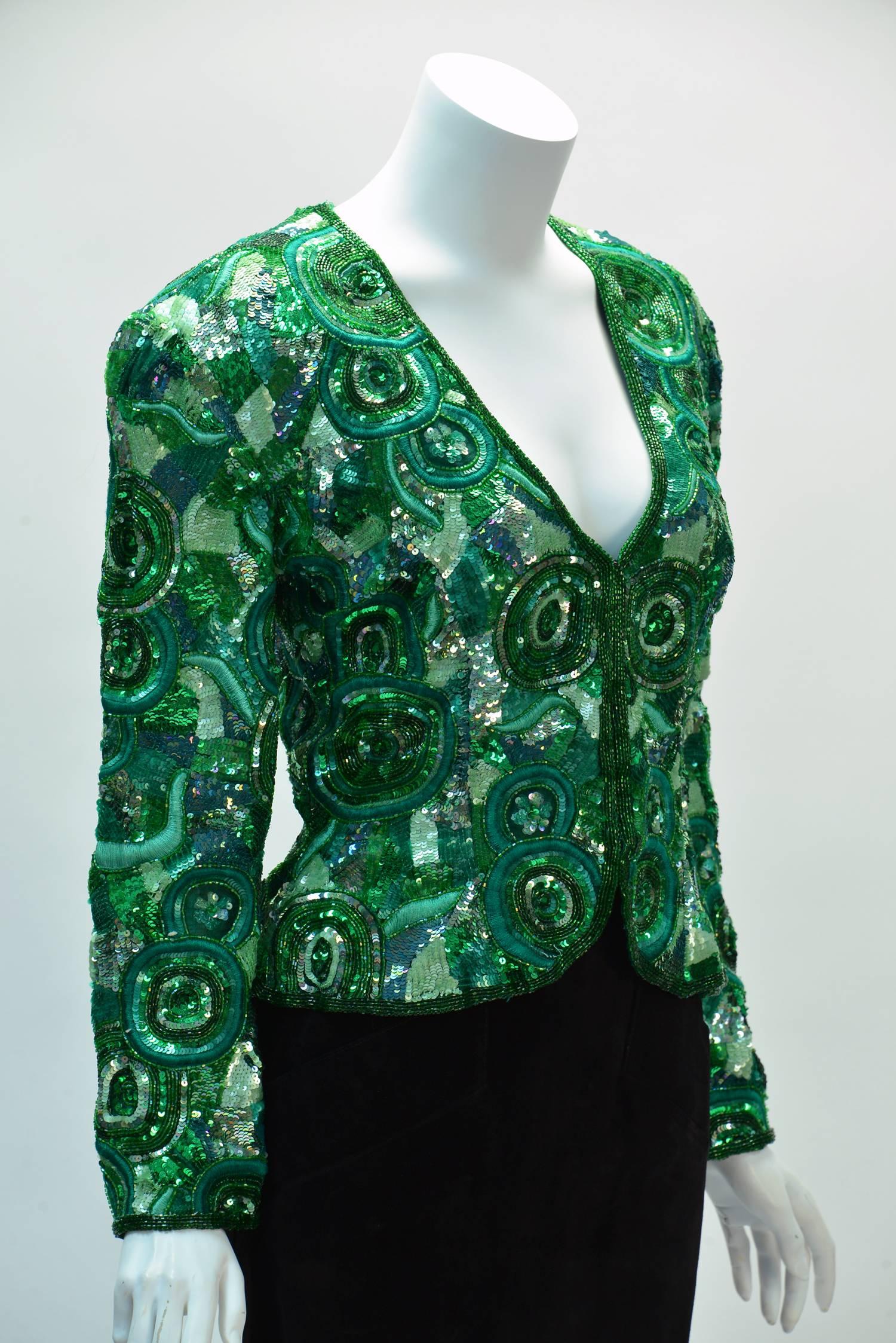  Festive Naeem Khan green sequin jacket created in the 1980's for his Riazee Line. Naeem Khan, known for his elaborate embellishment work, shows us how it is done with this jacket.  Embroidery and sequins throughout! Jacket has a plunging neck line