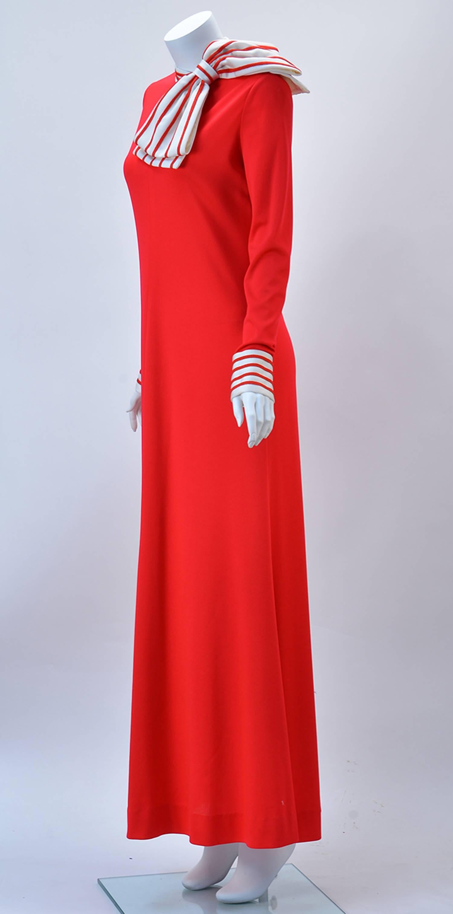 Fabulous red knit maxi dress with white and red large bow is a sumptuous  AND conservative beauty, but it is also amazingly comfortable! 

The red and white pattern can be found around the collar as well as on the cuffs of the sleeves. Trim on