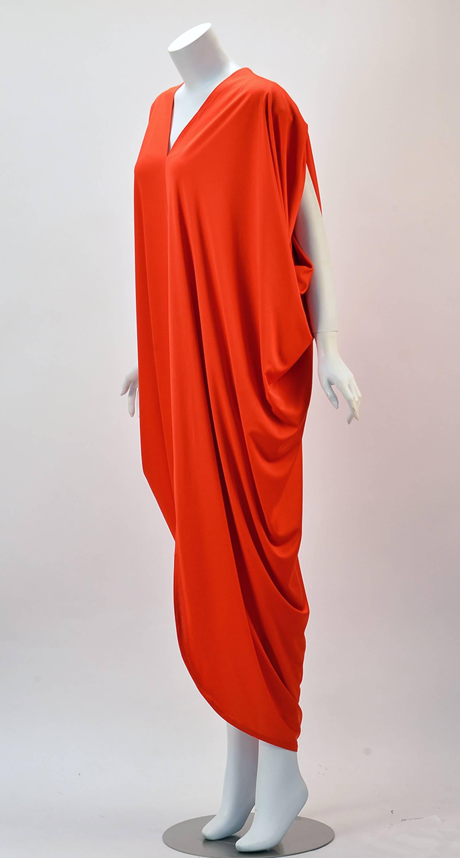 Make your Any Day comfortable and sexy in the gorgeous Adele Simpson show stopper from the 1970's.  

Made of knit, this dream dress begins with the V-neck and fashionable drape from the bust traveling to throughout and culminating in bat sleeves.