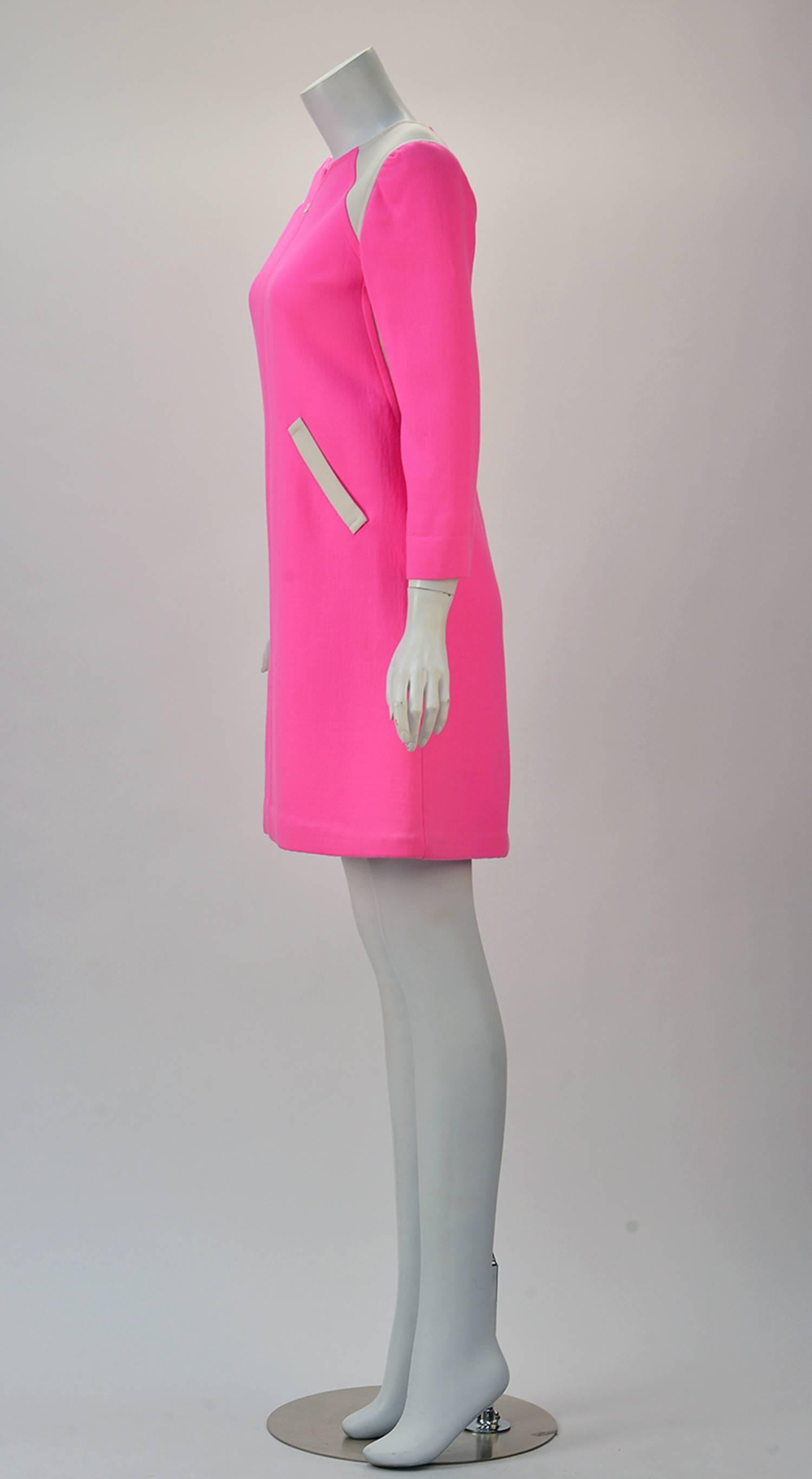 Courreges Paris fashion forward designed hot pink color blocked dress and silver zippered coat. Paying Homage to the sixties this color blocked mini gathers accentuate shoulders drawing the eyes up and down the dress. 

Subtle fit and flare