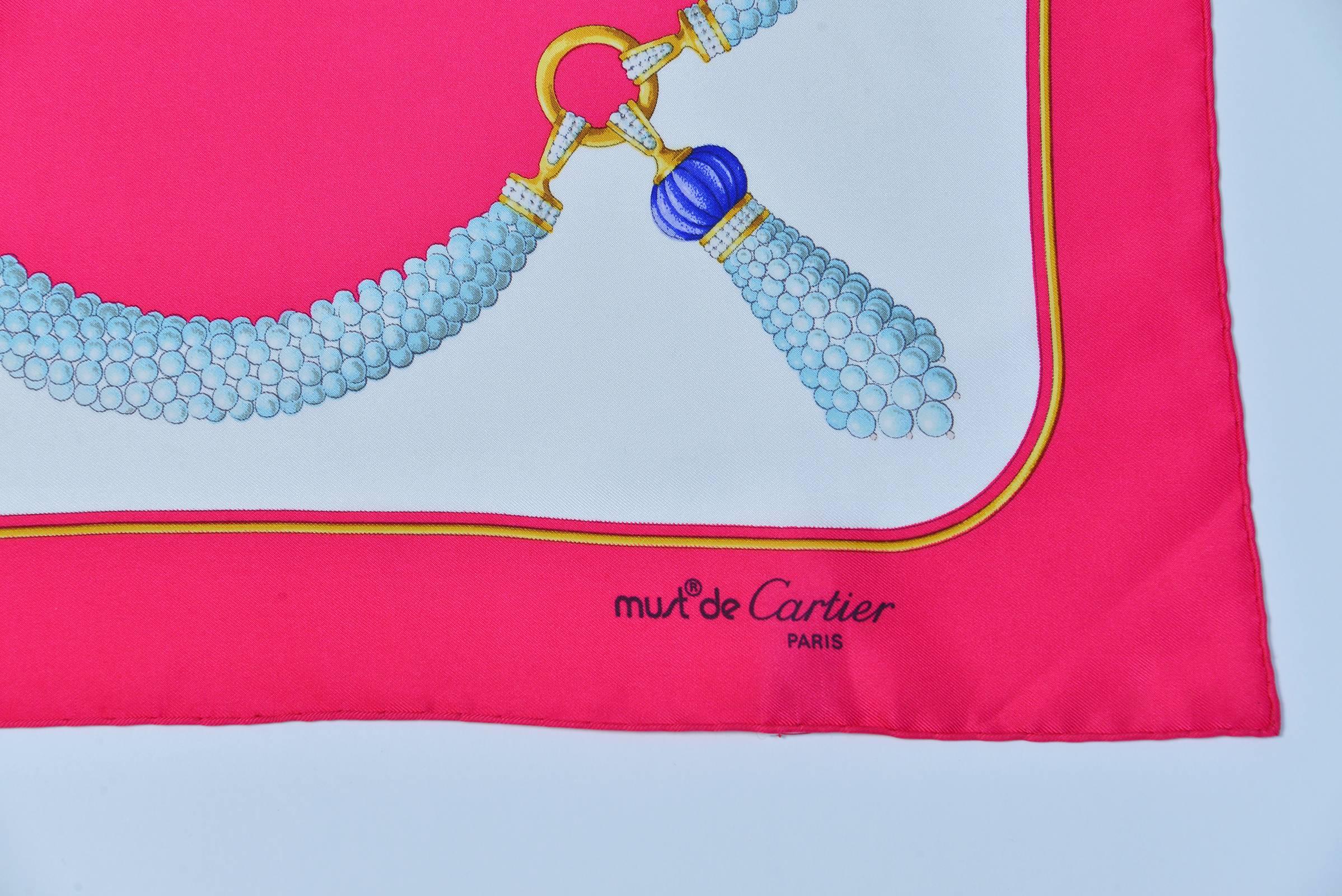 Beautiful Must de Cartier Paris classic pearl pendant style scarf is a perfect addition to a spring wardrobe.  The hot Pink & pearl necklace and tassels motif design adds a touch of refinement as well.  Elegantly done with wonderful detailing in the