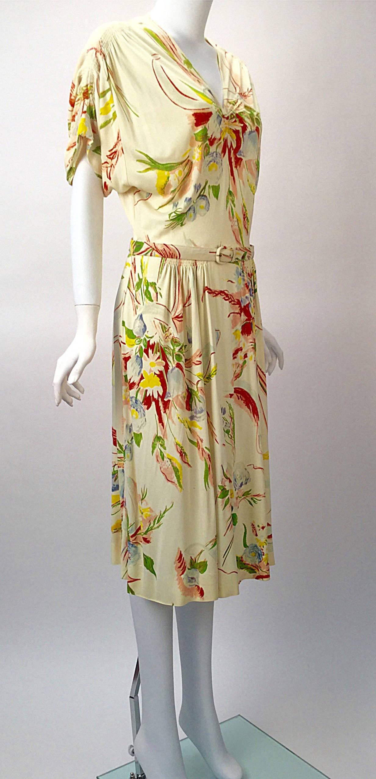 

Vintage 1930's Silk Jersey dress by Benham Original New York. Great gathered details on the sleeves and front. Beautiful floral pattern in spring colors. Delicate pleating at the waist. Floral belt included. 

Modern size small, 2

Bust: