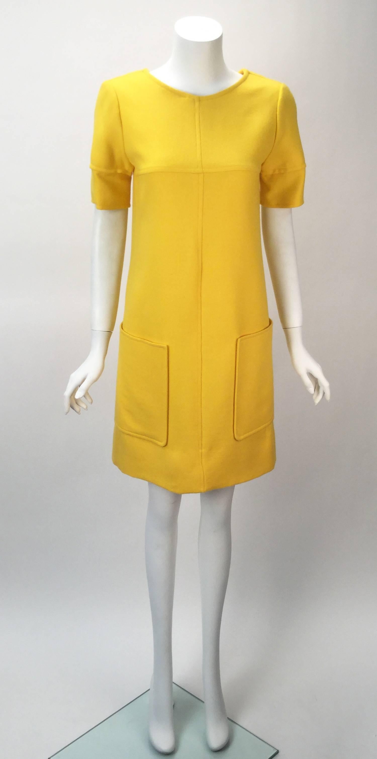 Awesome 1980's Courreges Yellow Dress And Cropped Jacket Ensemble. Dress has two large pockets. Seam going from neck to hem as well as across the bust. Sleeves feature the same seam. Zipper center back. 3" inch hem on bottom of dress.