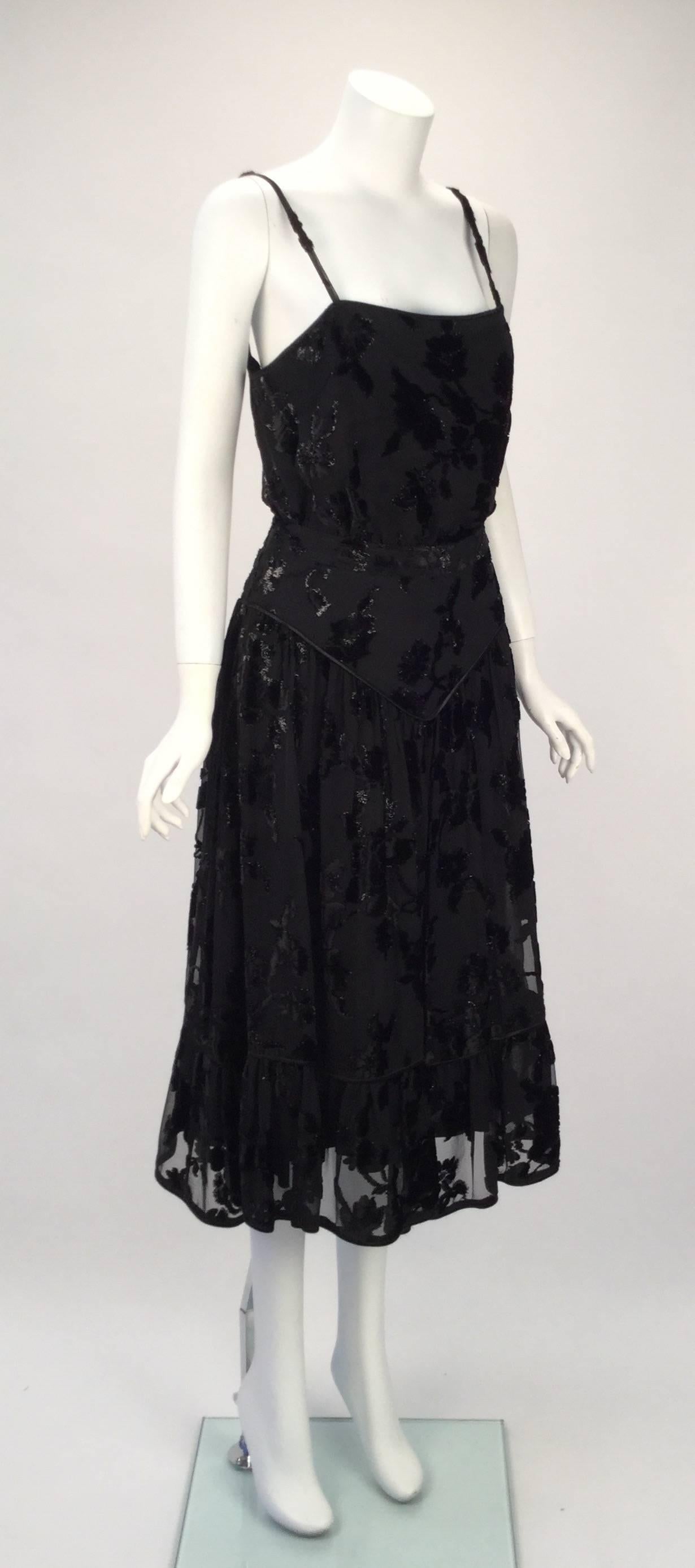 1980's Alan Austin top and skirt set. This striking top and skirt set is made of black chiffon and floral burn out velvet. The floral pattern is textured with metallic and velvet thread. The top is loose with spaghetti straps on a square neckline in