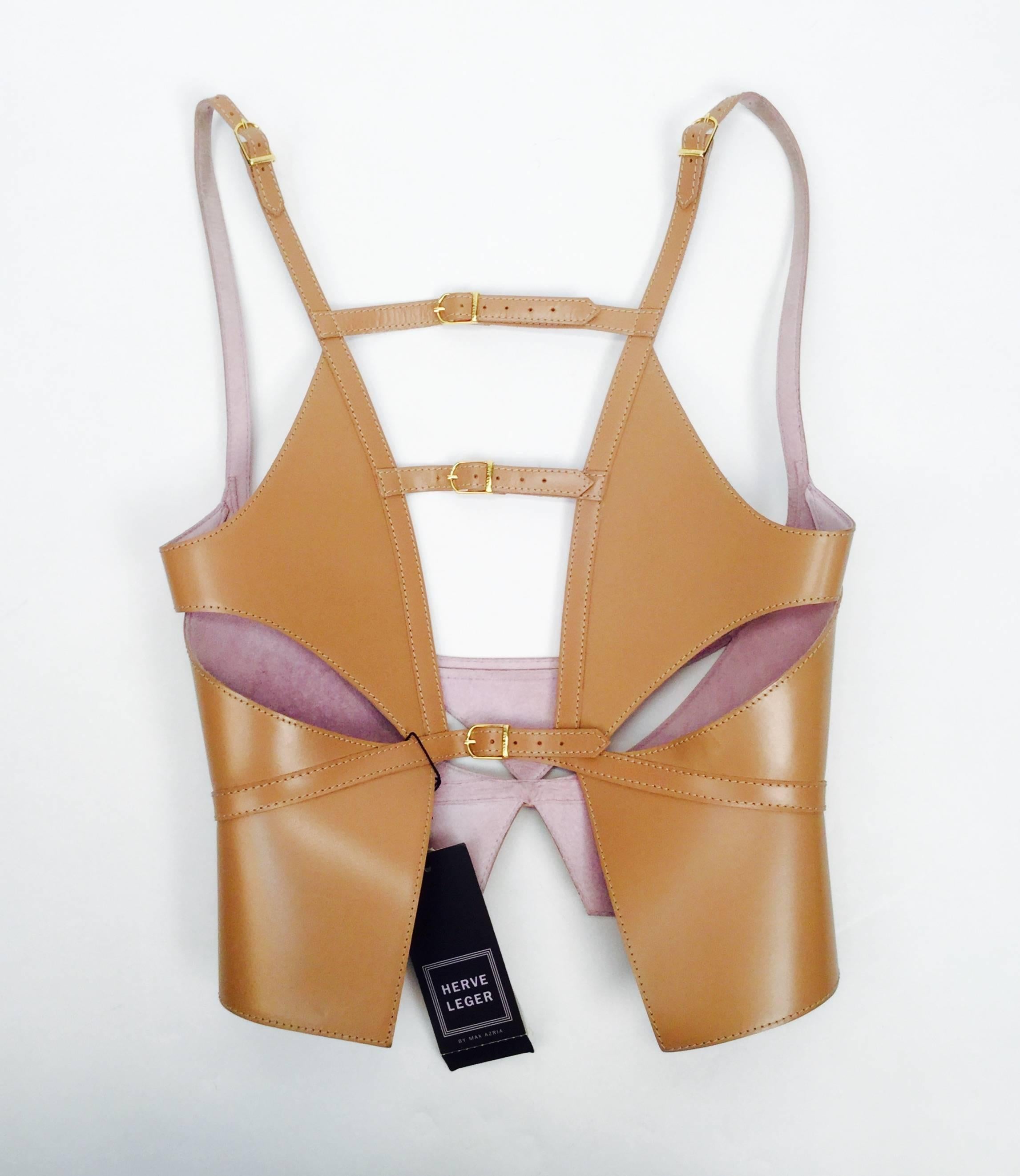 New with tags 2012 nude laser-cut leather harness belt by Max Azria for Herve Leger. The harness features gold tone metal hardware and elaborate top stitching. The cut-outs are geometric in design. The shoulder straps and back straps are adjustable.