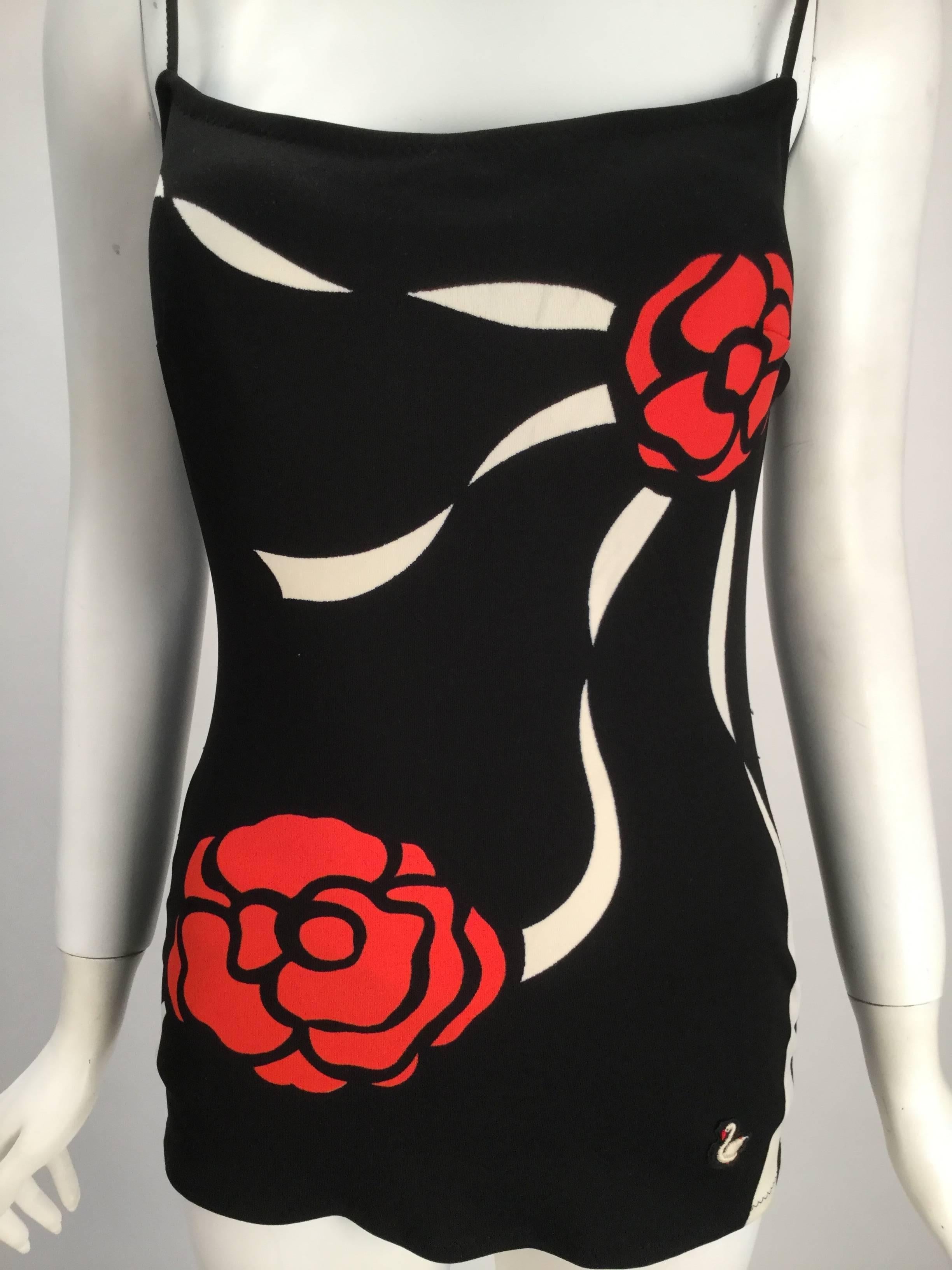 1960s Herma Black bathing suit with two roses connected by white lines on the front. Back is solid black. Low back, thin straps. Swim suit is made from 100% Helanca (nylon).  Fantastic!

Modern size 2

*All garments and accessories have been
