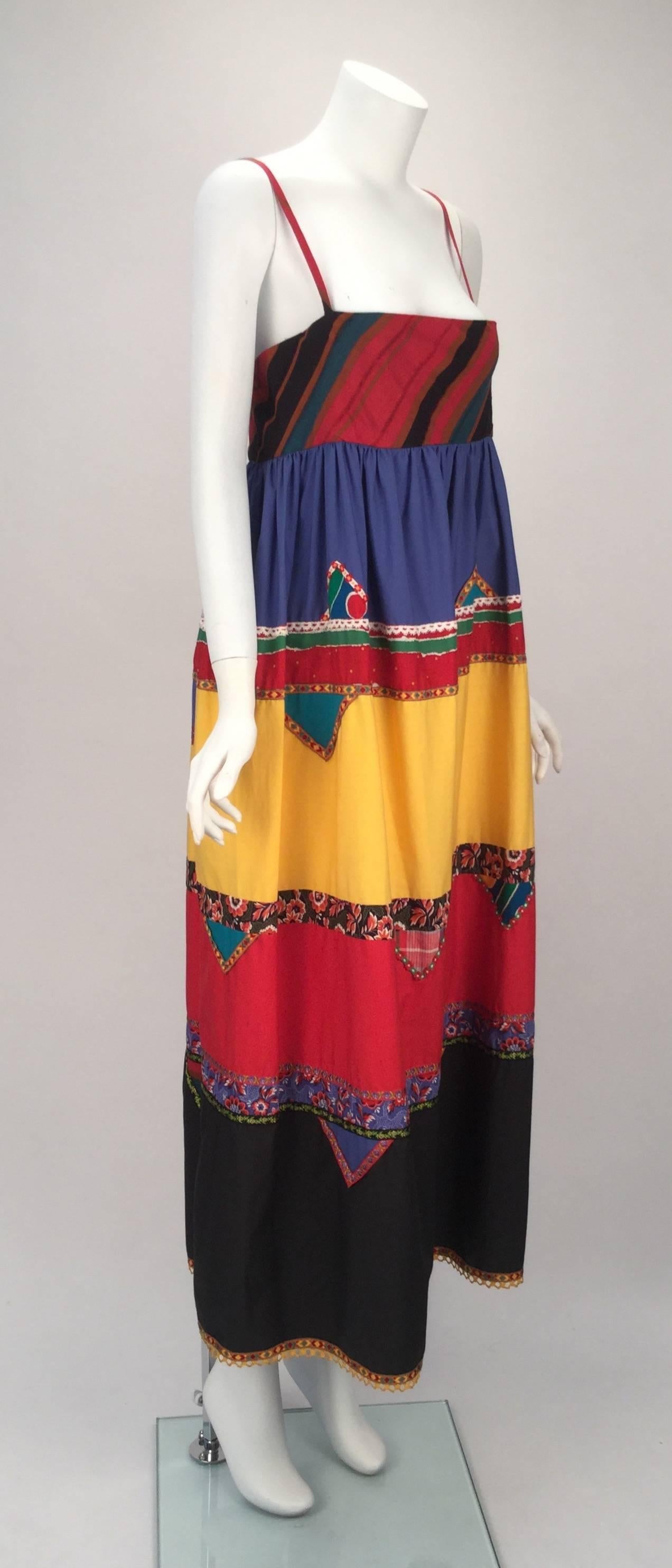 1980s Giorgio Sant' Angelo empire waist, sleeveless dress with bright color and print blocking.  As was his natural inclination,  Sant' Angelo reference the American Indian in his use of colorful mix of trim to border each color blocked shape.   It