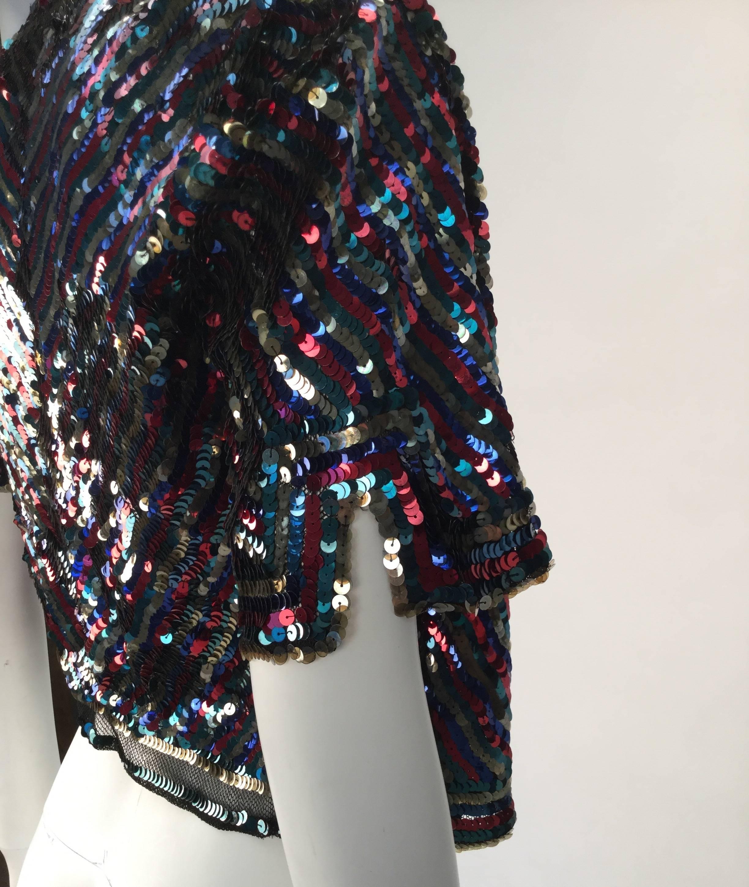 
1940s bolero that has been stored so wonderfully it could vouch as a disco era piece!  Simply magnificent. 

It is multicolor with beautifully placed diagonal sequins and wonderfully excuted elbow length sleeves with blouson shouldering and side