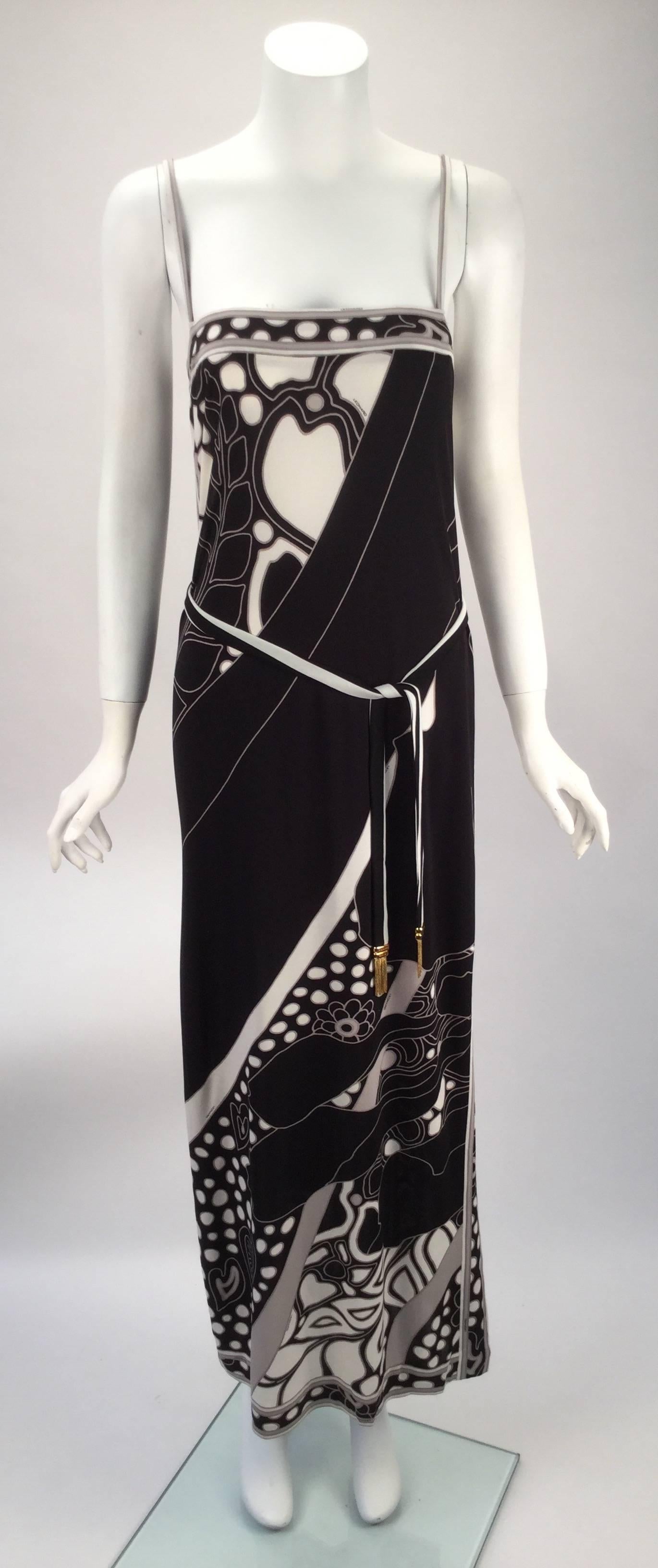 Said to have been inspired by the beautiful leopard moth this silk jersey knit spaghetti strap dress has a black and white print. Print design is highlighted with grey. Dress has a left split hem. Straight column silhouette. The jacket is originally