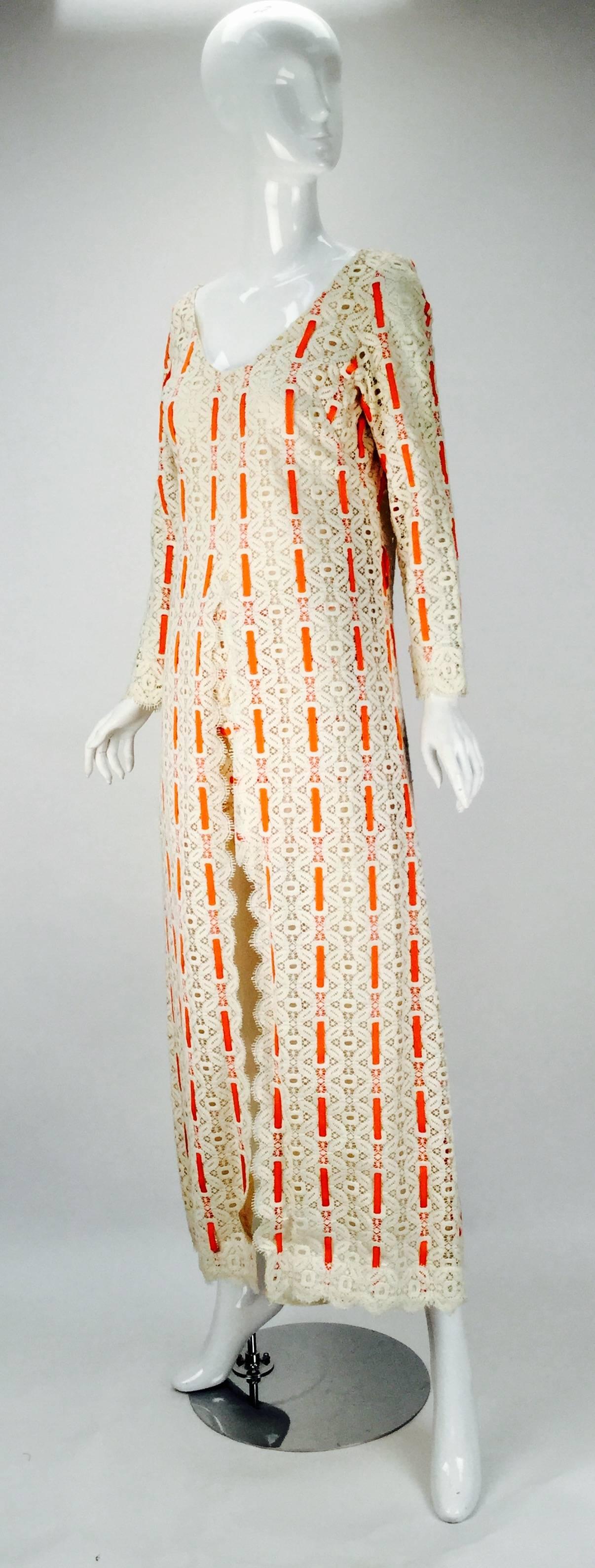 Fantastic 1970s lace ensemble with orange grosgrain ribbon that is woven vertically throughout the overdress and shorts. The outfit was originally from the high-end Houston boutique, Esther Wolf. Both garments are lined with organza. The long