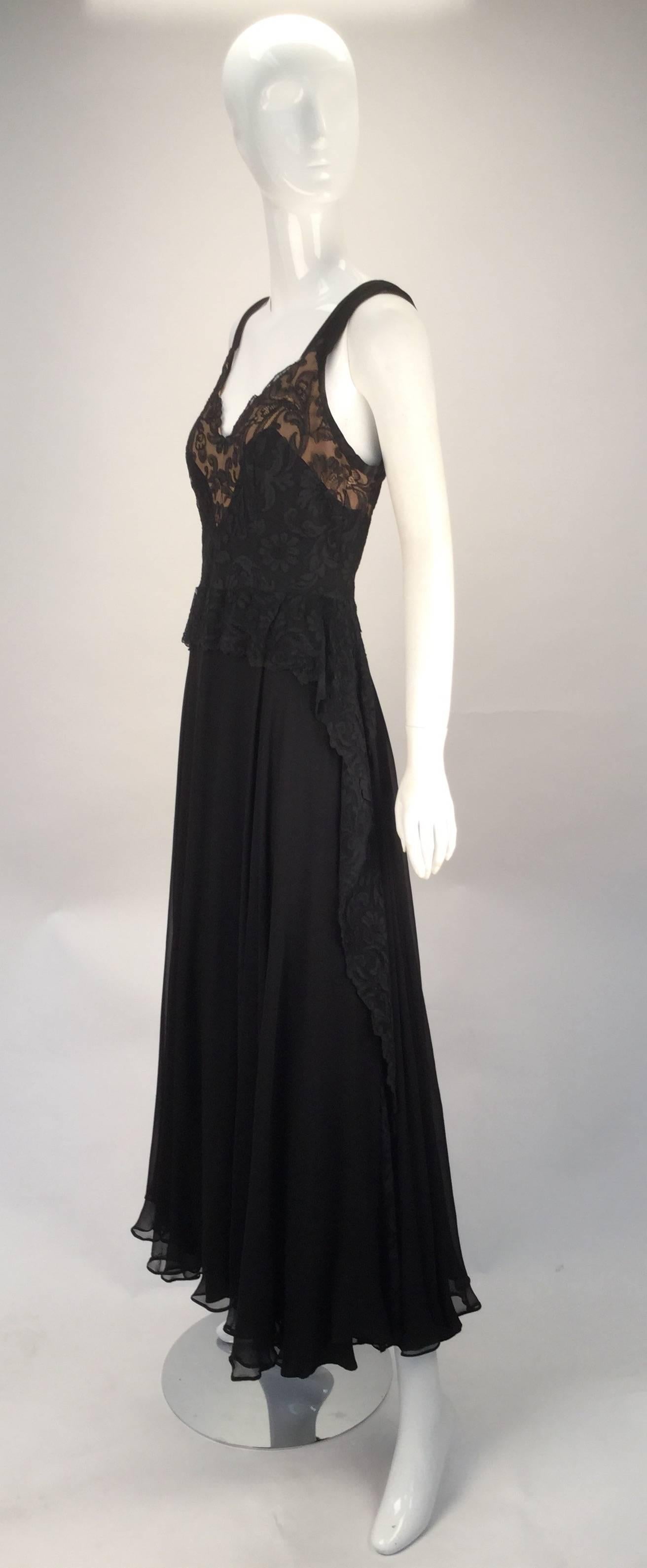 
Wonderful black silk sleeveless evening dress with sweetheart neckline. No label but clearly custom made. The dress features a black lace/net overlay on bodice, with the lace creating a peplum design at front waist. Flounce down each side of the