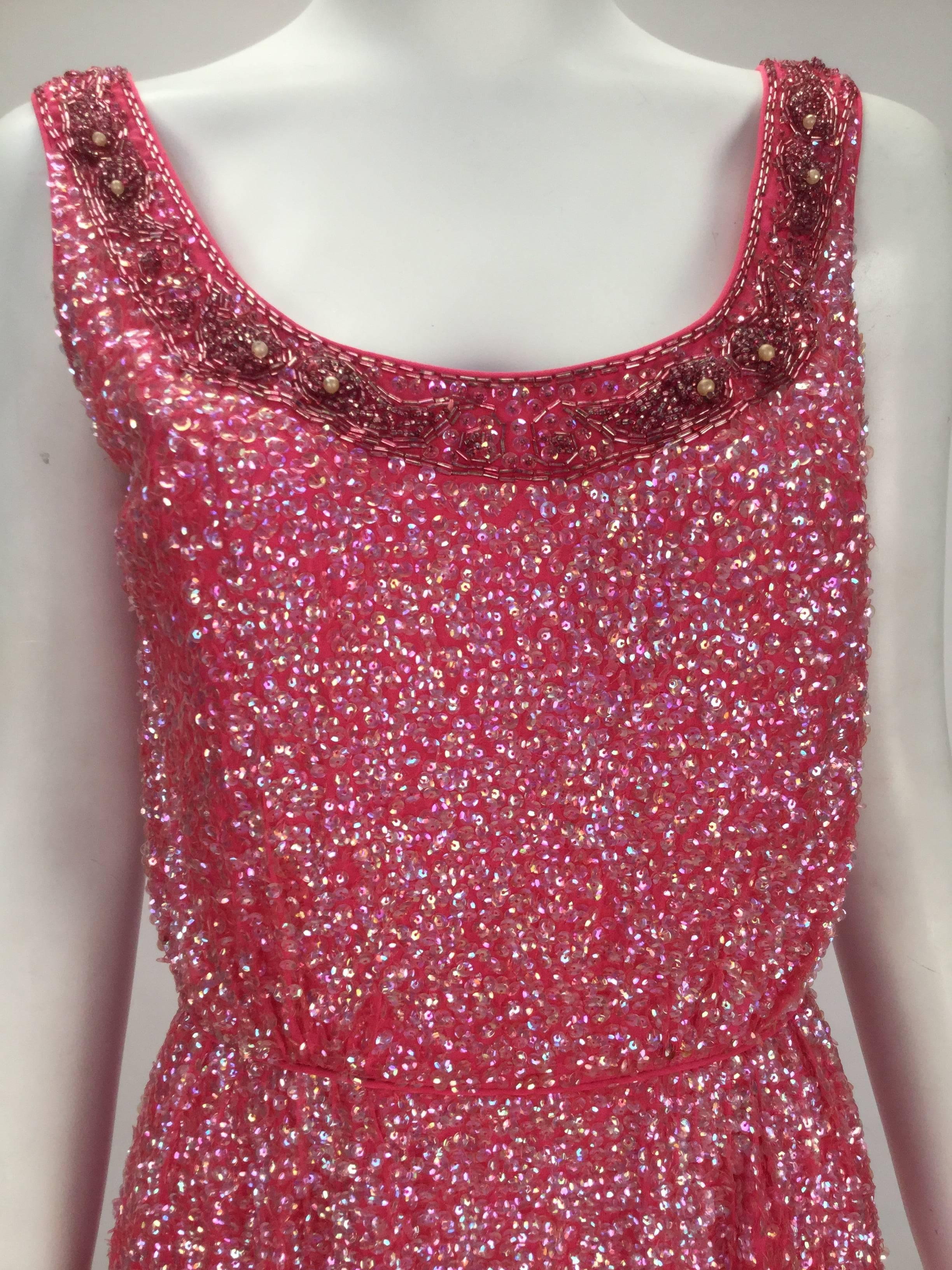 Dazzling 1960's bubblegum pink silk sleeveless dress, with sequins throughout. Beading borders a scoop neckline.  Made exclusively for the high-end Houston boutique - Esther Wolf, in the British Crown Colony of Hong Kong.  Piping trim throughout the