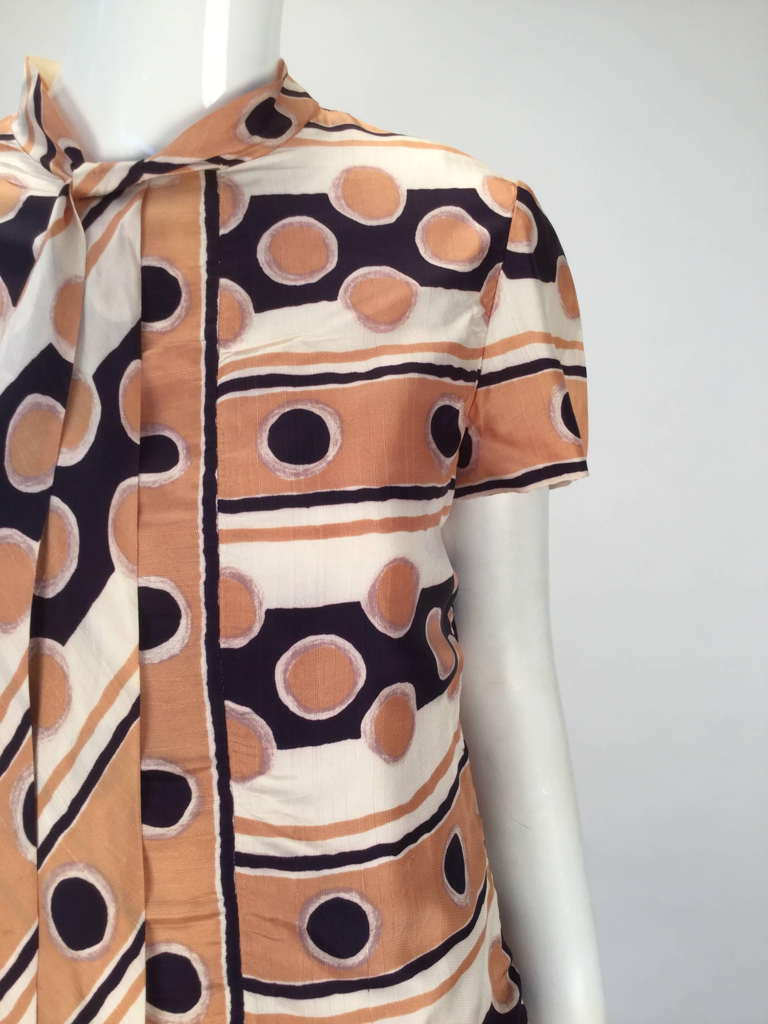 Very early 1970's Oscar de la Renta silk mod print dress and jacket ensemble. Multicolored stripe and polka dot print. The collared jacket has long sleeves with cuffs. Two snap closures on each cuff. Fabric covered snap closures down center front,