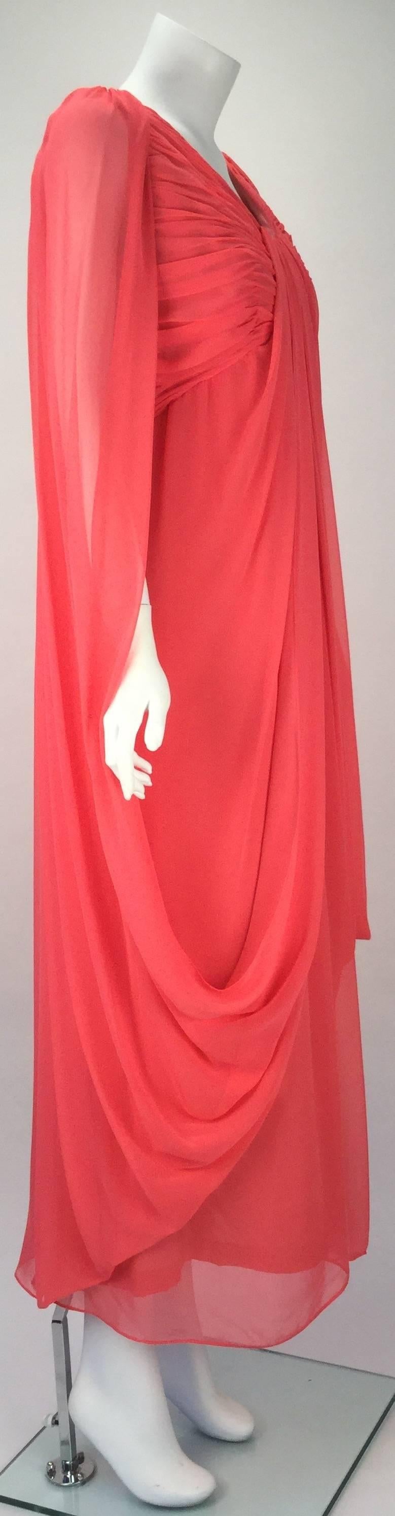
Ethereal 1970's coral colored sleeveless chiffon evening dress with draping by Victor Costa.absolutely beautiful! 

The front of the dress has ruching at the bust. Chiffon fabric drapes from the front bust down to the skirt and around the back and