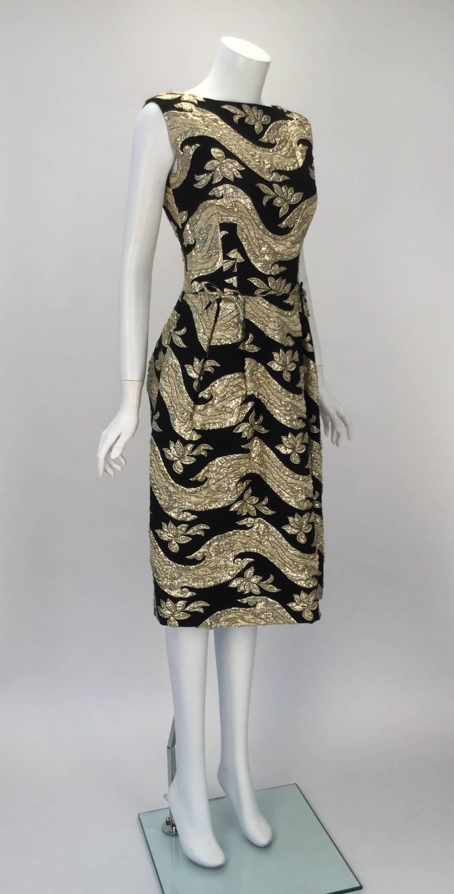 This Hannah Troy dress is perfect for any season, any time of day, or any type of event!  It has a fantastic fit as well!

Dress is black with gold lame patterns all over the dress. Two sweet small bows can be found on the waistline of the dress.