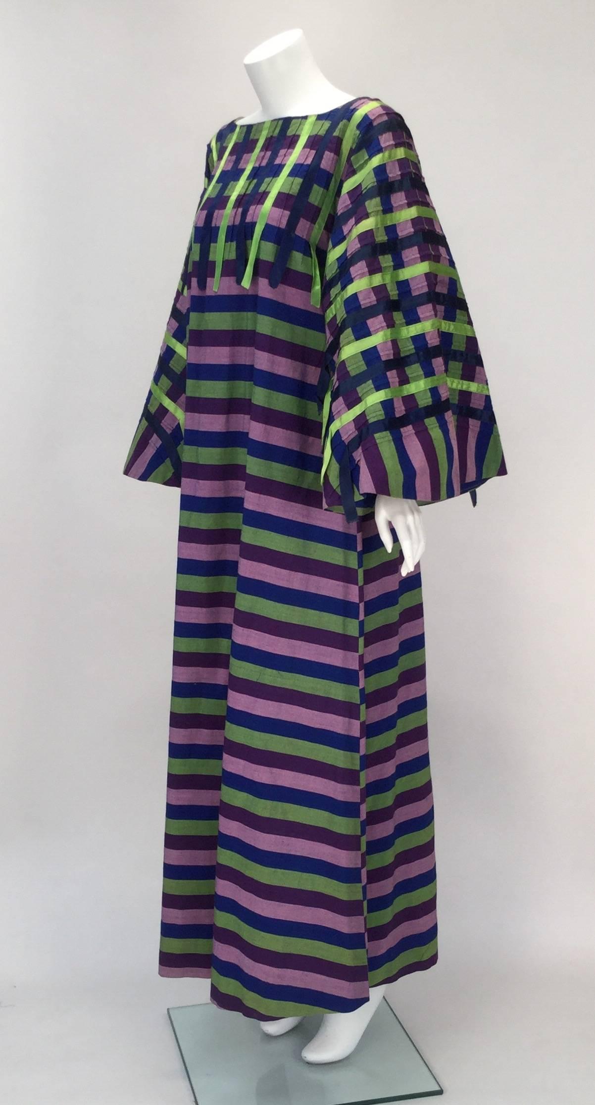 
Awesome looking and comfortable comes this Mexican made and multi colored and cotton kaftan.  

Designed and hand made by Nelly of Puerta Vallarta for wealthy International Travelers in the late 1960's this kaftan has green and blue ribbon
