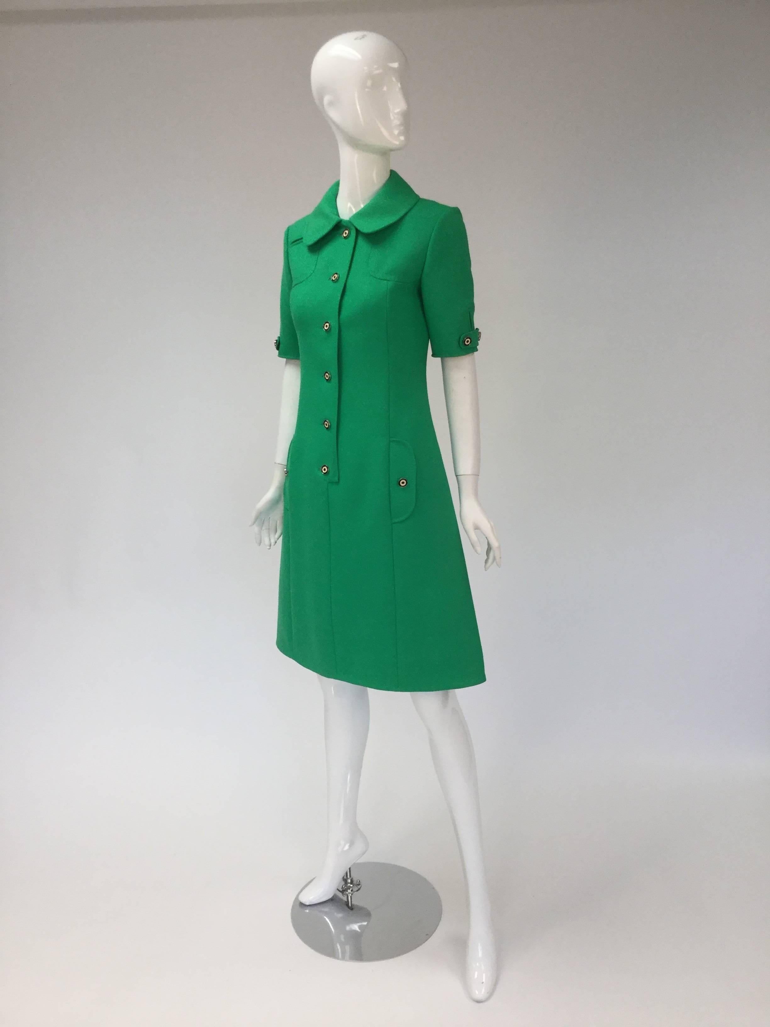Wonderful and classic green wool dress from Louis Feraud.  Wear it day or night, dress it up or down with flats for a 60's vibe or heels for a power look.  

Dress features six black and white buttons running down the front center of dress, as