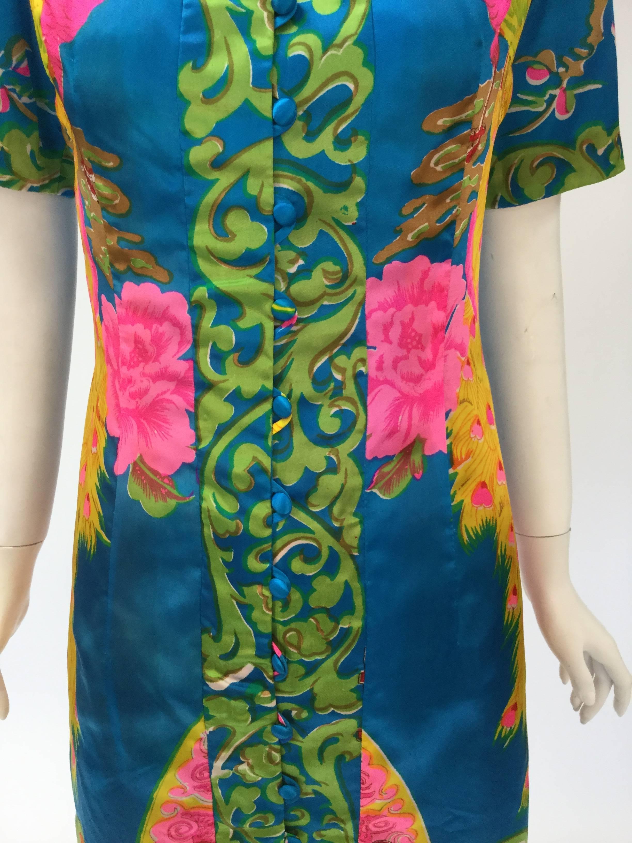 Fantastic print maxi dress features two Flamingos and a floral pattern. Designed in the British Crown Colony of Hong Kong in the early 60's and made by Sam Sung, a dressmaker to travelers from the west.  

This fantastic gown is made of satin it