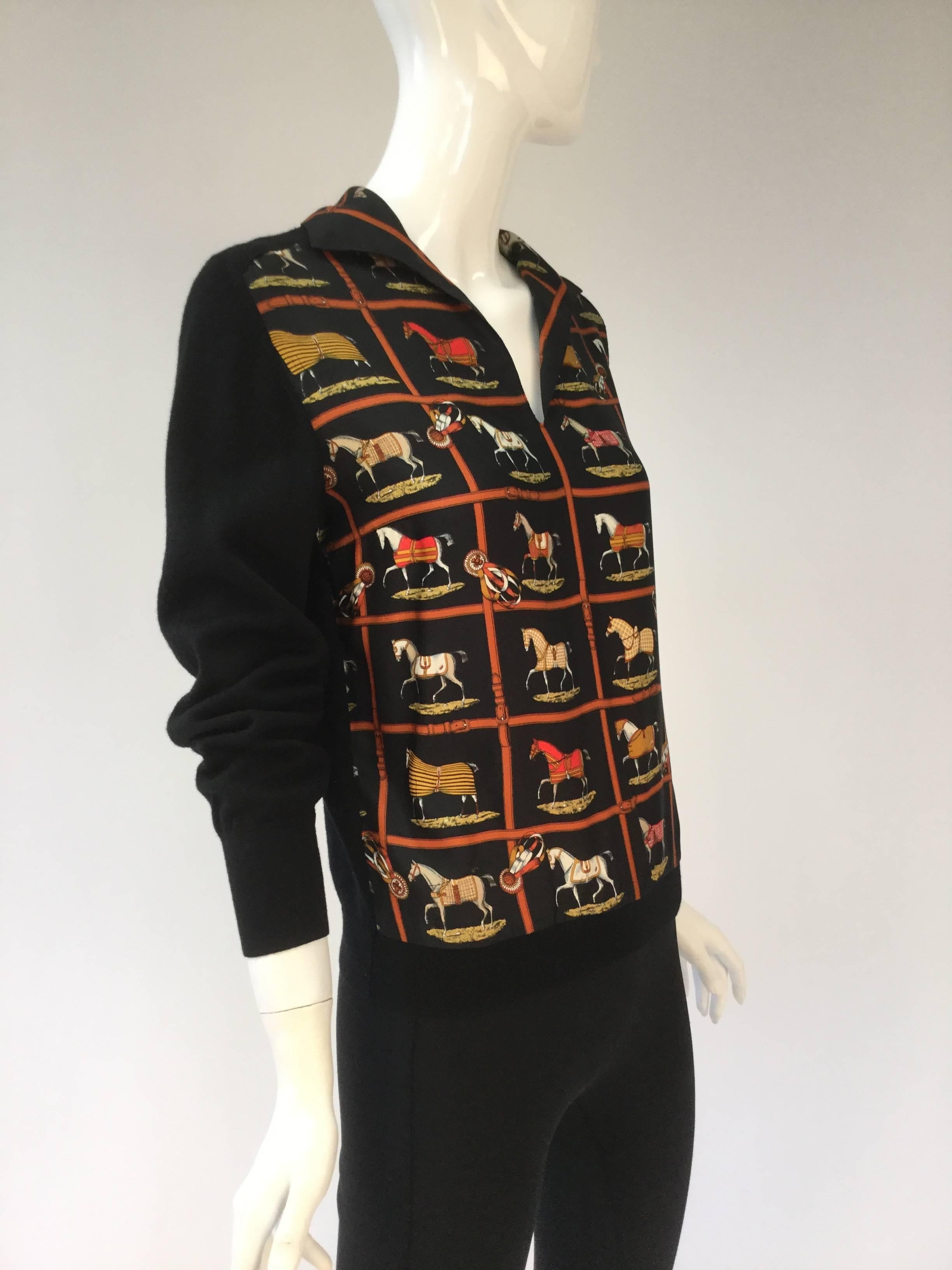 Classic sweater with the beloved Jaques Eudel scarf print designed in 1974 as its front.   Silk collar, neck dips into a v back and sleeves made of wool.  We beleive the scarf print was turned into a sweater in the 1980's by Hermes and sold.* 

This