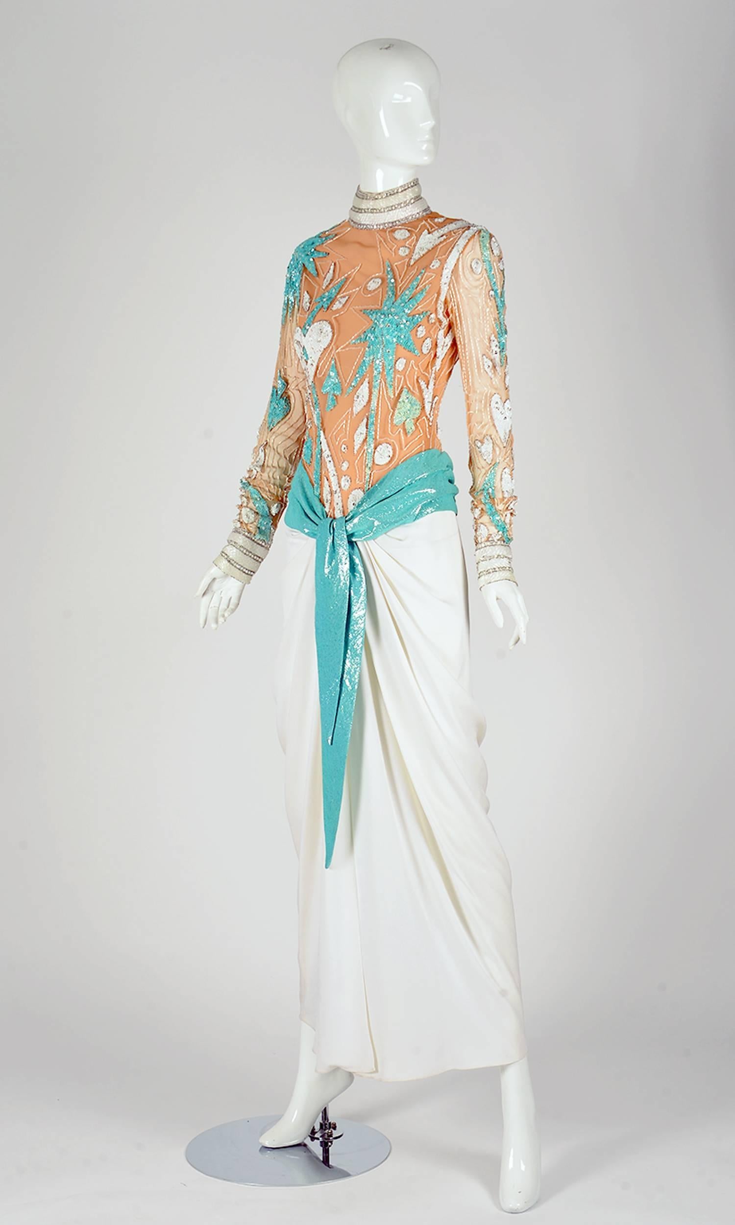Vintage Bob Mackie gown. This fantastic 1980s floor length evening gown is turquoise blue, white, and has a nude mesh bodice with fantastic beaded details. The beading and sequins are turquoise blue and white, and create whimsical star and heart