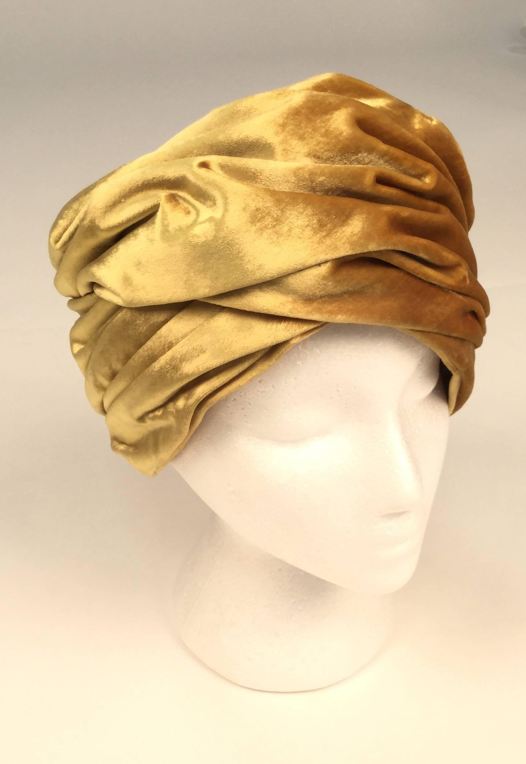 Fantastic 1960s Christian Dior gold velvet turban. 

Dress it up!  Dress it down!  Use it as a prop, art, or just covet this wonderful creation.

Excellent condition lined with gold silk grosgrain fabric.

Hat Measures 22