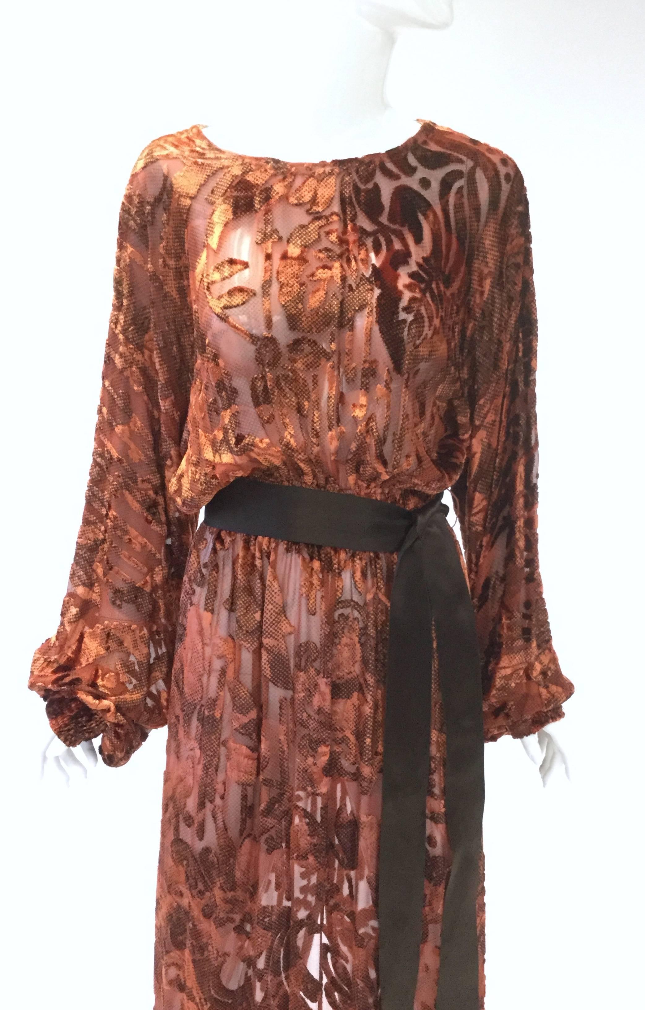 Gorgeous vintage silk Devoré dress. With its long, romantic, cuffed bishop sleeves, gathered blouson waist, and bateau boat neck, this amber-tone dress is undeniably full of bohemian charm! The dress features an intricate floral and paisley burnout