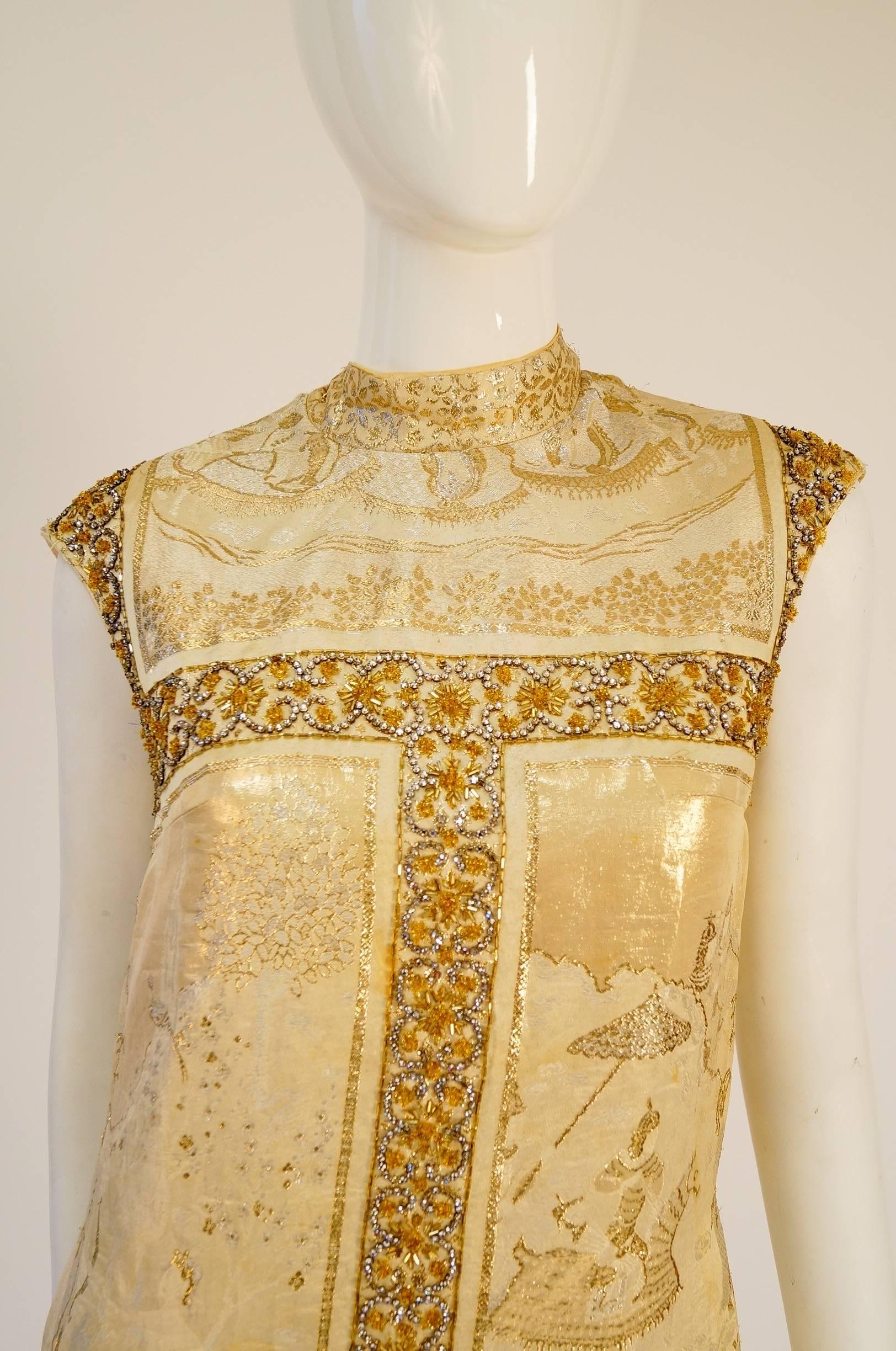 Vintage Gold Asian Nature Scene Brocade, Bead, Rhinestone Dress

Absolutely stunning vintage dress. The dress is composed of eight panels, each depicting the same wilderness scene with wildlife, men in armor on horses, an archer, and a goddess