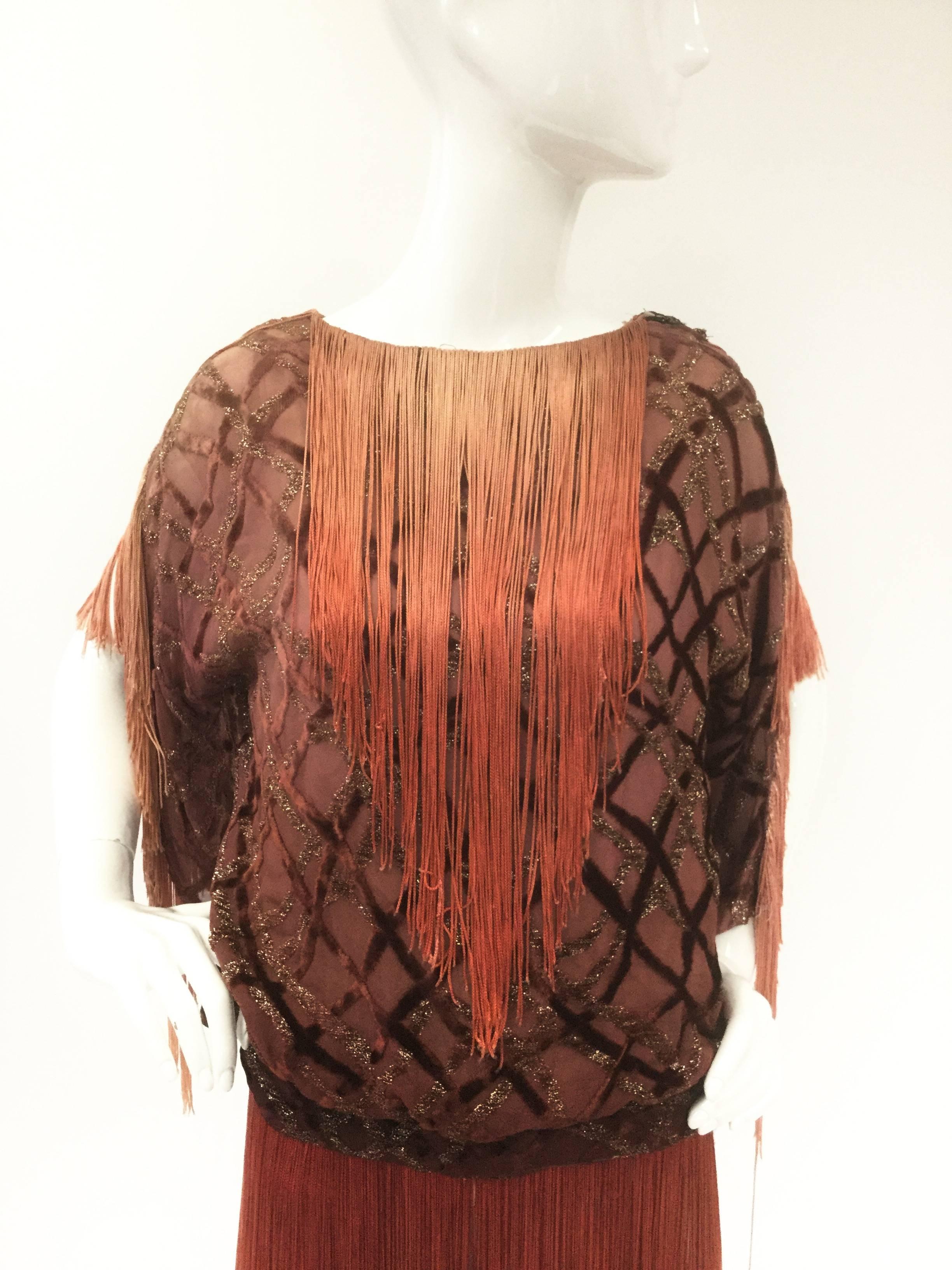 Absolutely impeccable 1920s flapper tunic! This gorgeous piece is composed of a drop waist sheer blouse with cross-crossing velvet diamond lattice overlaid with a gold thread lattice. The blouse has a built-in camisole. The bateau boat collar of the