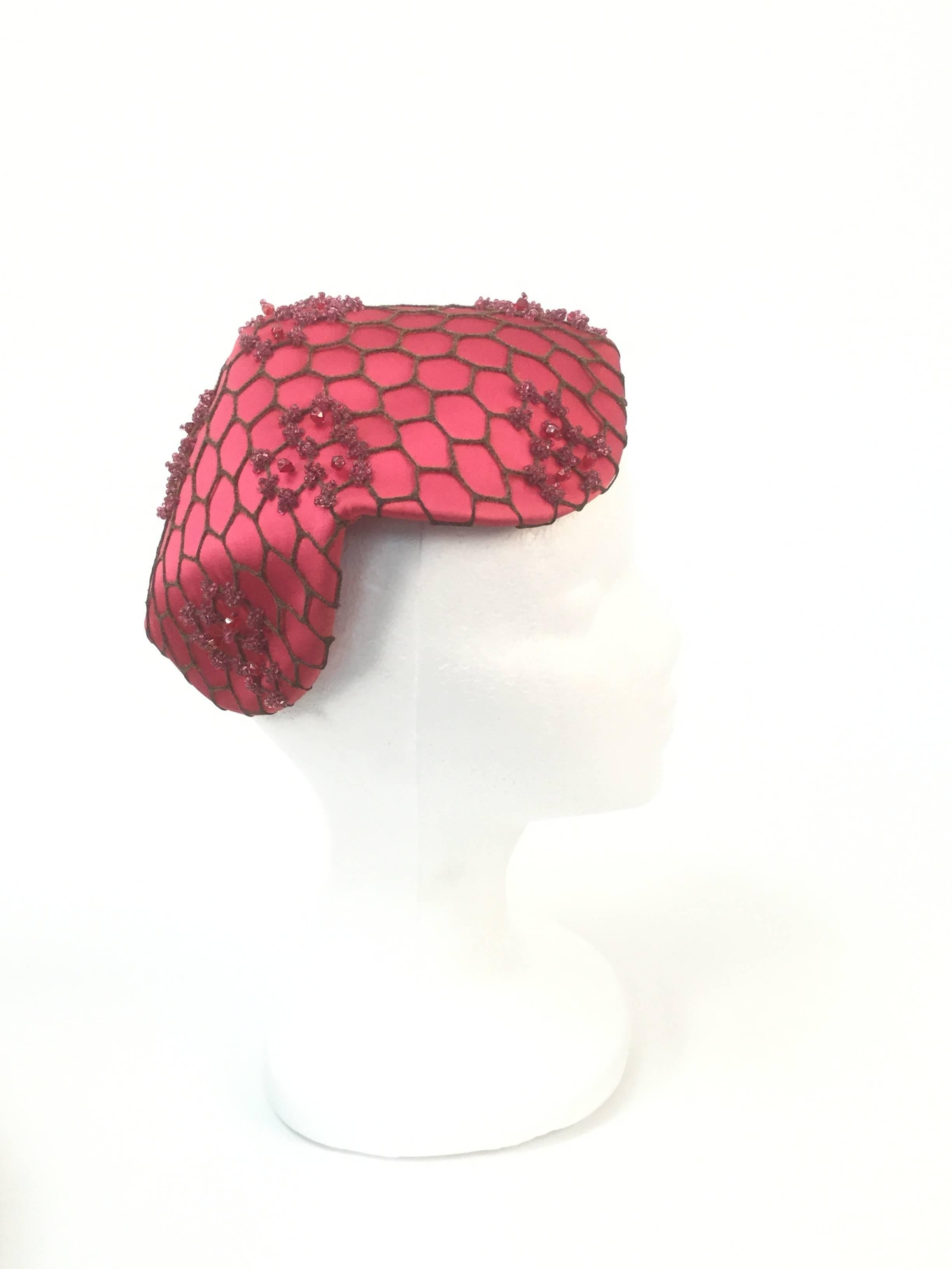 
Gorgeous bright pink hat by John Fredrics! John Frederics, in his later years known as Mr. John created pure couture with this lux piece of work.

Honeycomb beauty is composed of pink satin, arranged in a pyramid-like shape, with curved,