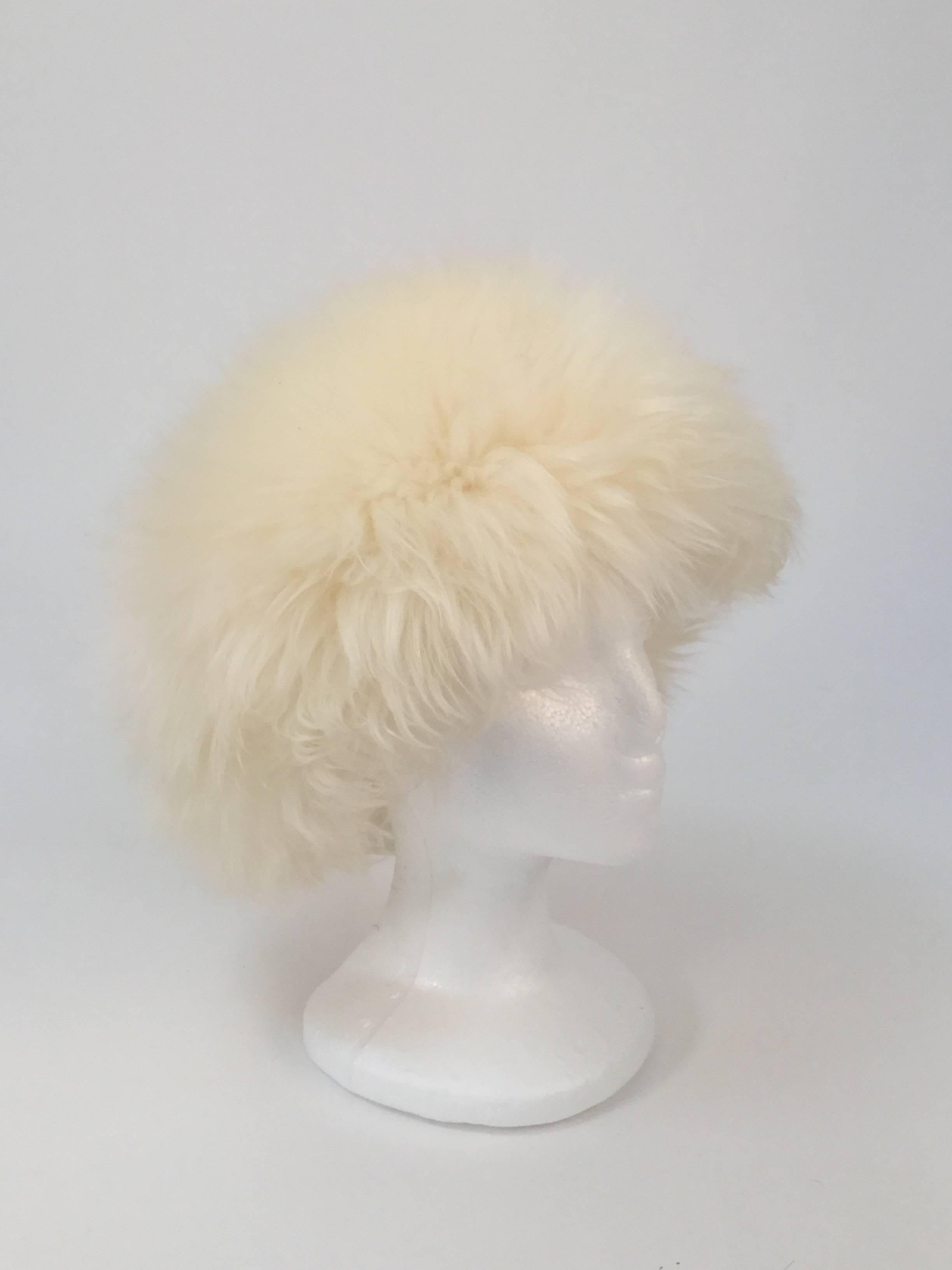 
Absolutely luxurious cream-white tuscan lamb skin fur hat! This gorgeous, plush hat is composed of genuine tuscan lamb skin fur, brushed out into a soft, wonderful, cushioned texture. The hat has a knit band, and the interior of the hat features