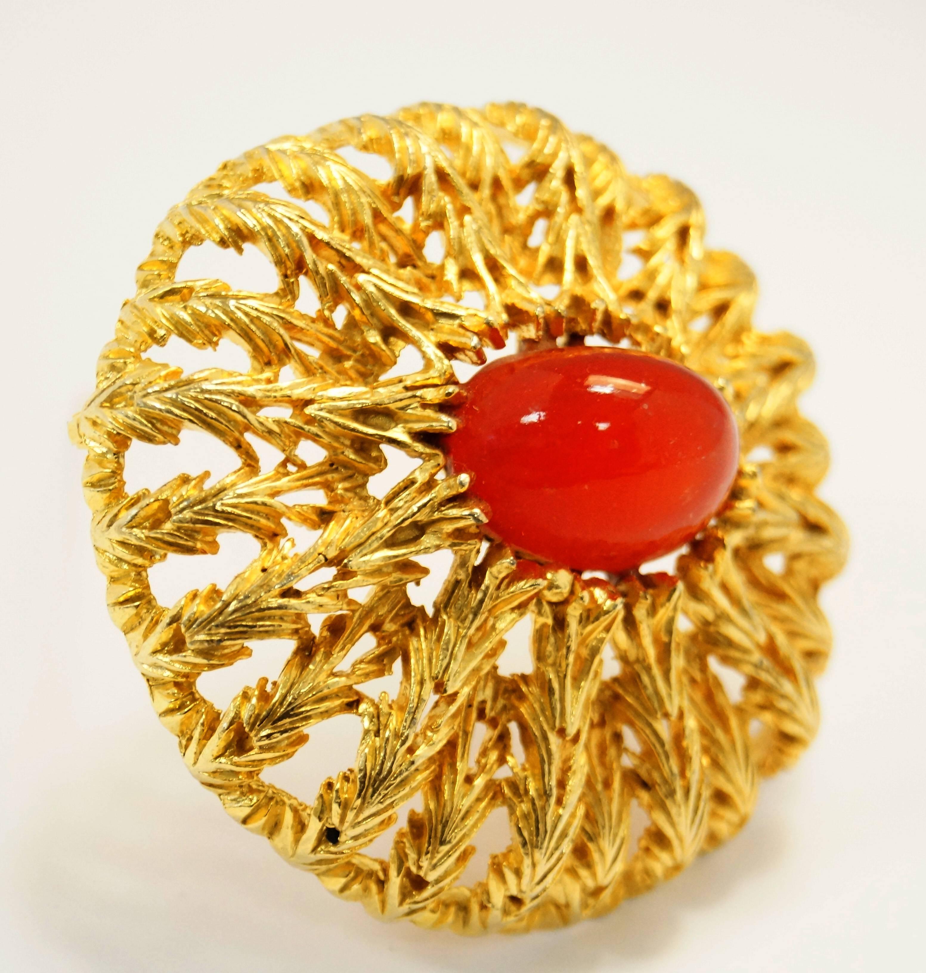 
Absolutely show stopping vintage brooch by Elsa Schiaparelli! This brooch features an oval vermillion cabochon surrounded by organic chevron-shaped floral flourishes in a radial pattern, creating a gorgeous and ornate sunburst design. 

*All