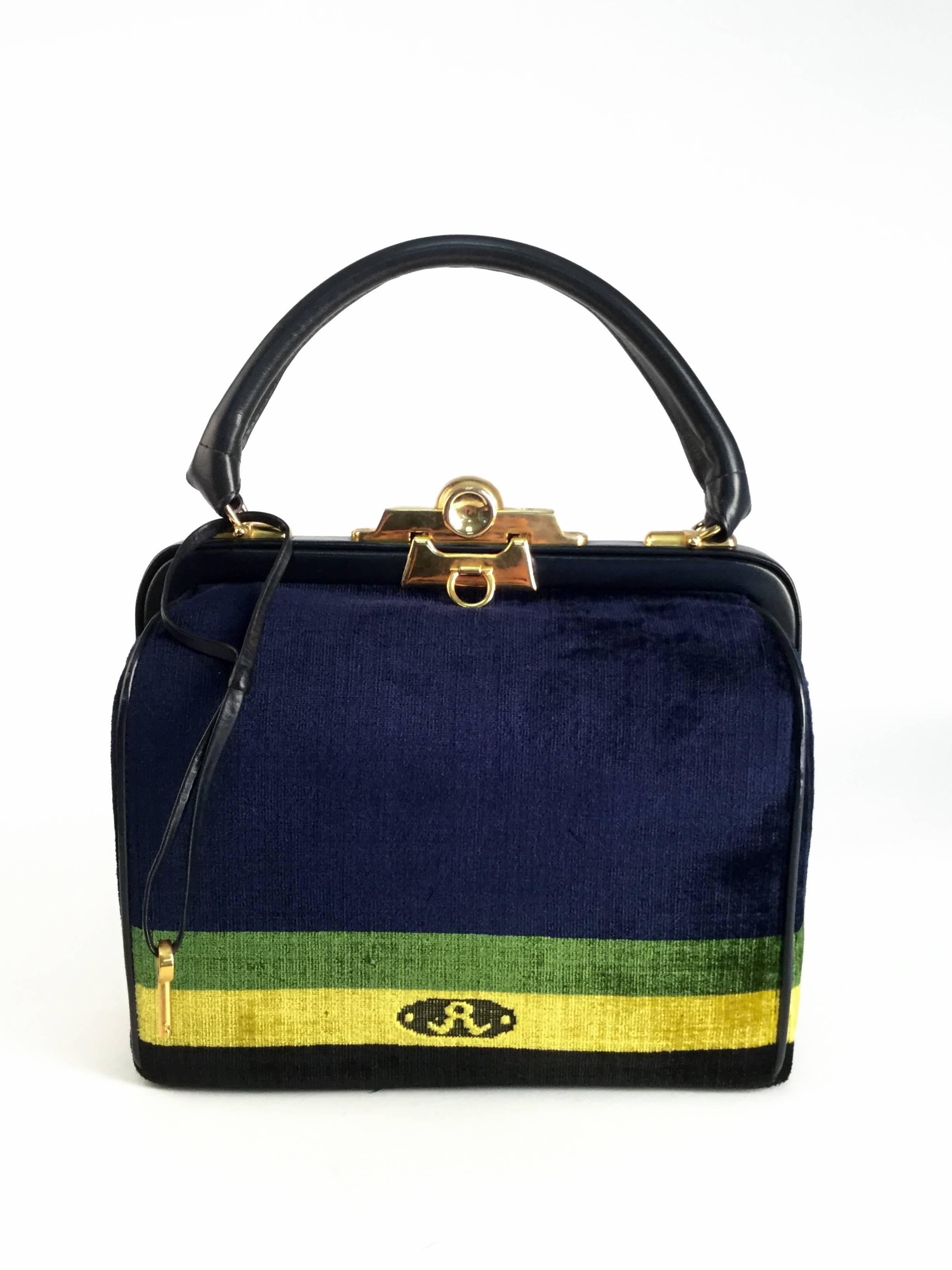 
This vintage purse by Roberta di Camerino is a beautiful luxurious, plush, and absolutely stunning interpretation of the classic austere doctor bag! The distinctive Roberta di Camerino "R" logo is situated on the lemon yellow stripe.  The