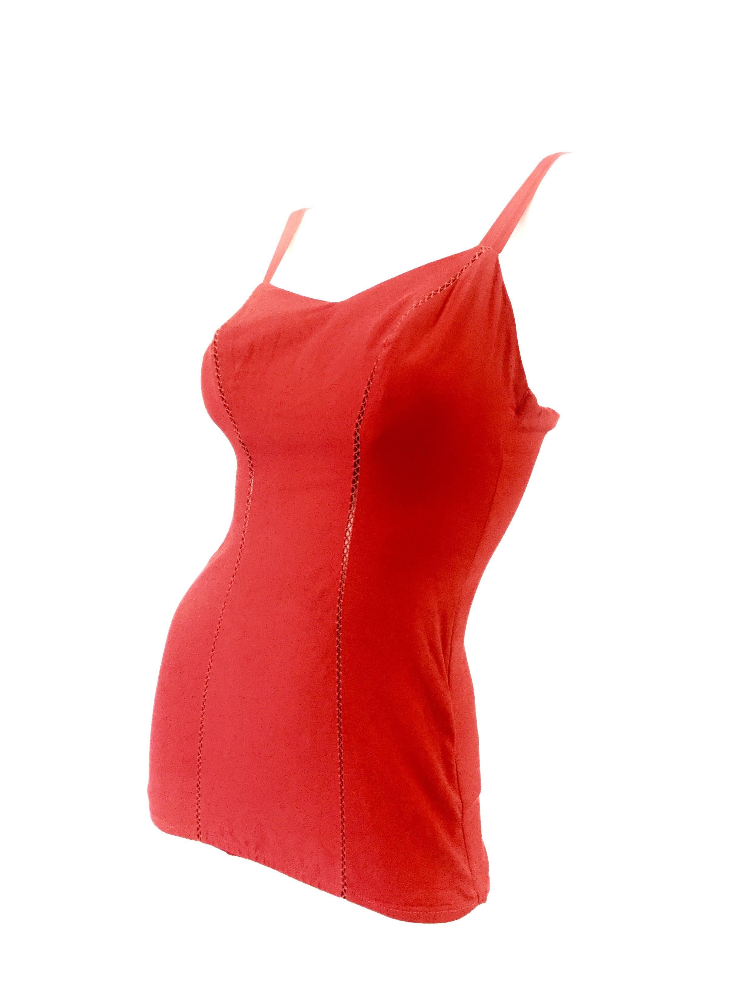
Striking sweetheart swimsuit by Jantzen! This one piece suit is composed of several long panels of red fabric stitched together, leaving a gap between panels, but held together by an elaborate zigzag stitch. There is a bandeau strip on the bust,