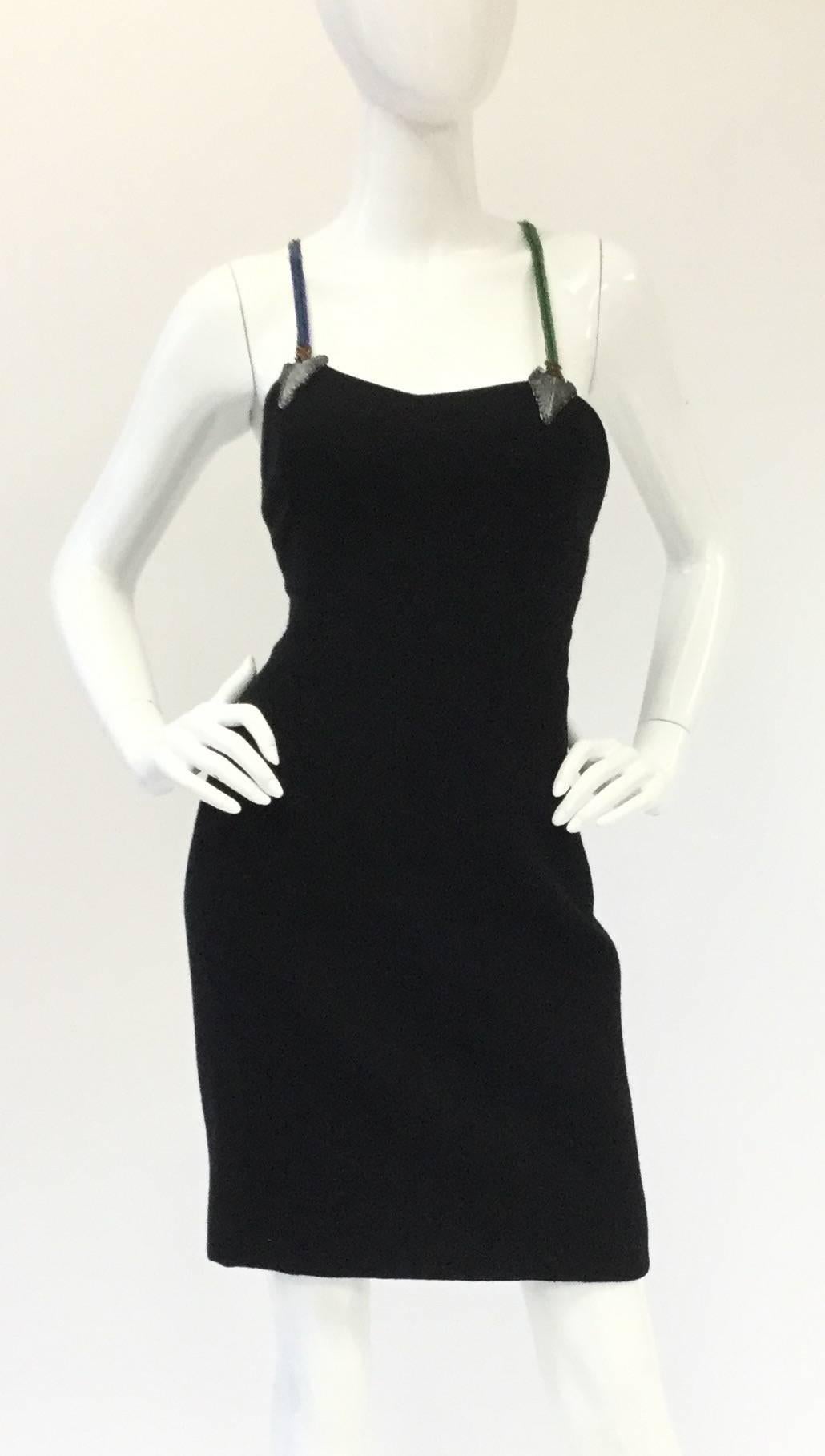 
Bob Mackie does it again with this fantastically whimsical arrow strap dress! The back...the back...

This little black dress with a twist is mid-thigh length and has a subdued sweetheart necklinein front.  Walaa! the straps in back are