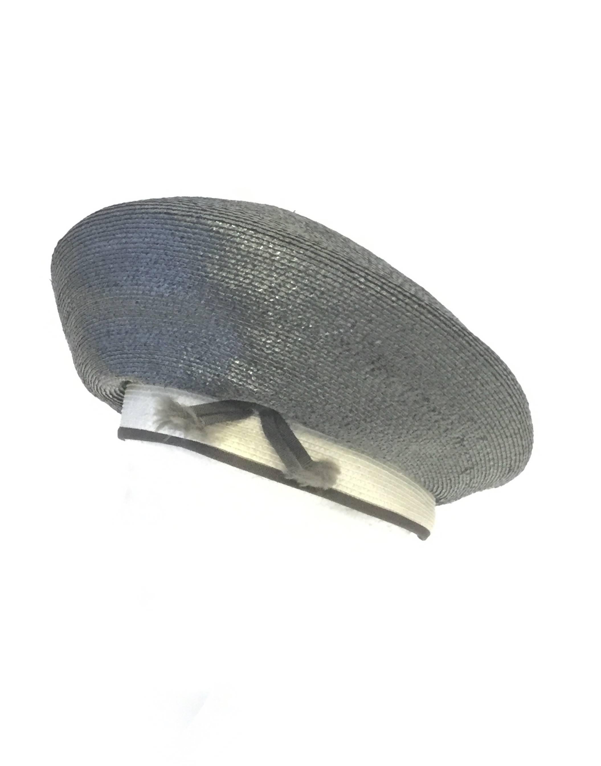 
Playful Elsa Schiaparelli "Miss Schiaparelli" beret! This woven hat has a white band accented by two tassel-end fringe ribbons. The blue beret bubble top of the hat slouches gently over the band, and features an "X"; at the top.