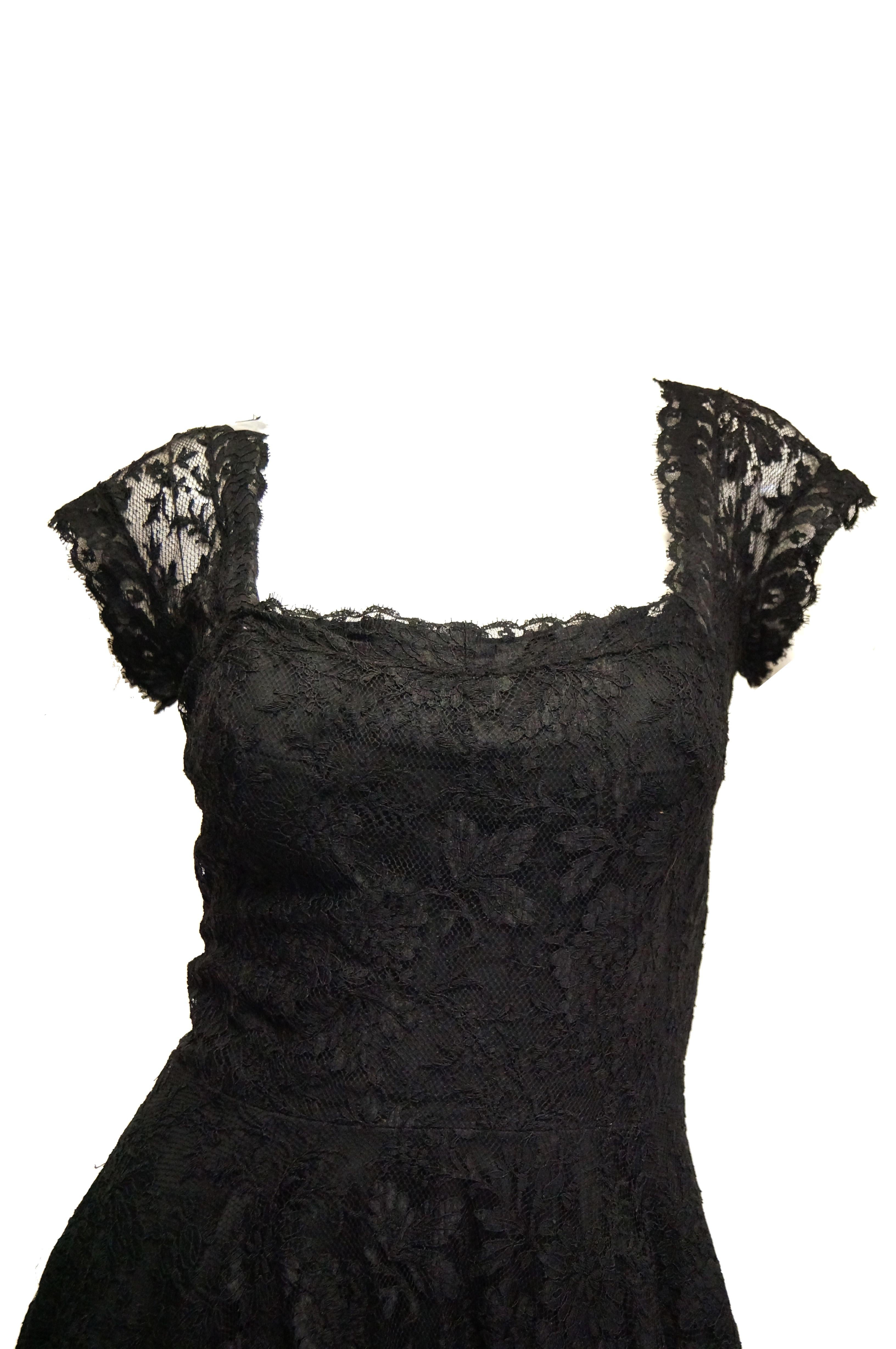 Beautiful black floral lace evening dress. The dress has an a - line silhouette with a rather full skirt, fitted bodice, short capped sleeves, a low, square neckline, and a surprisingly low scoop back (rather scandalous for the 1950s!). Zipper in