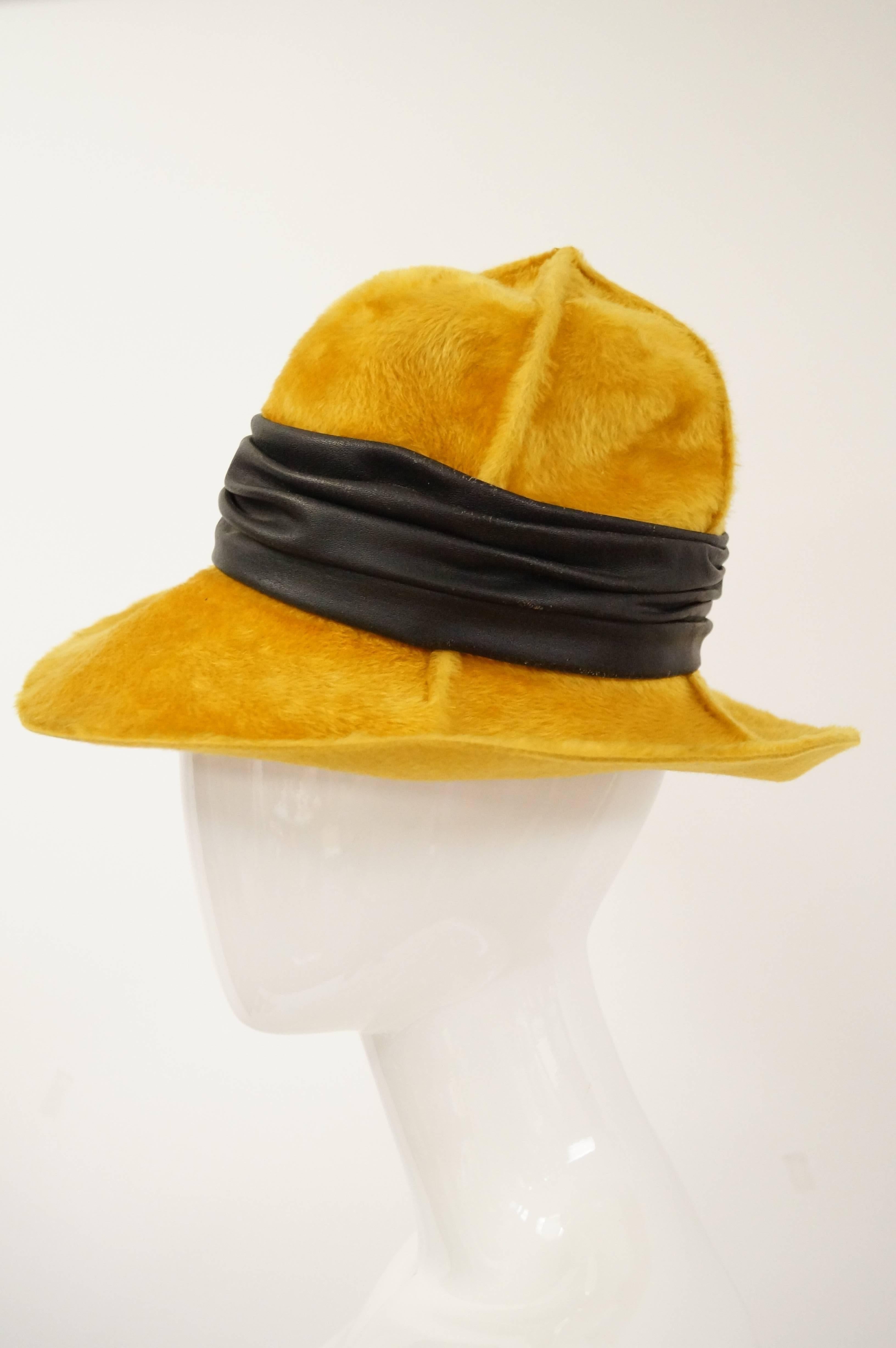Fabulous wide brim hat by Christian Dior in soft, velveteen fabric. The hat has a tall crown composed of four panels stitched together in an "x." The hat features a wide, ruched leather ribbon.

Small 21"