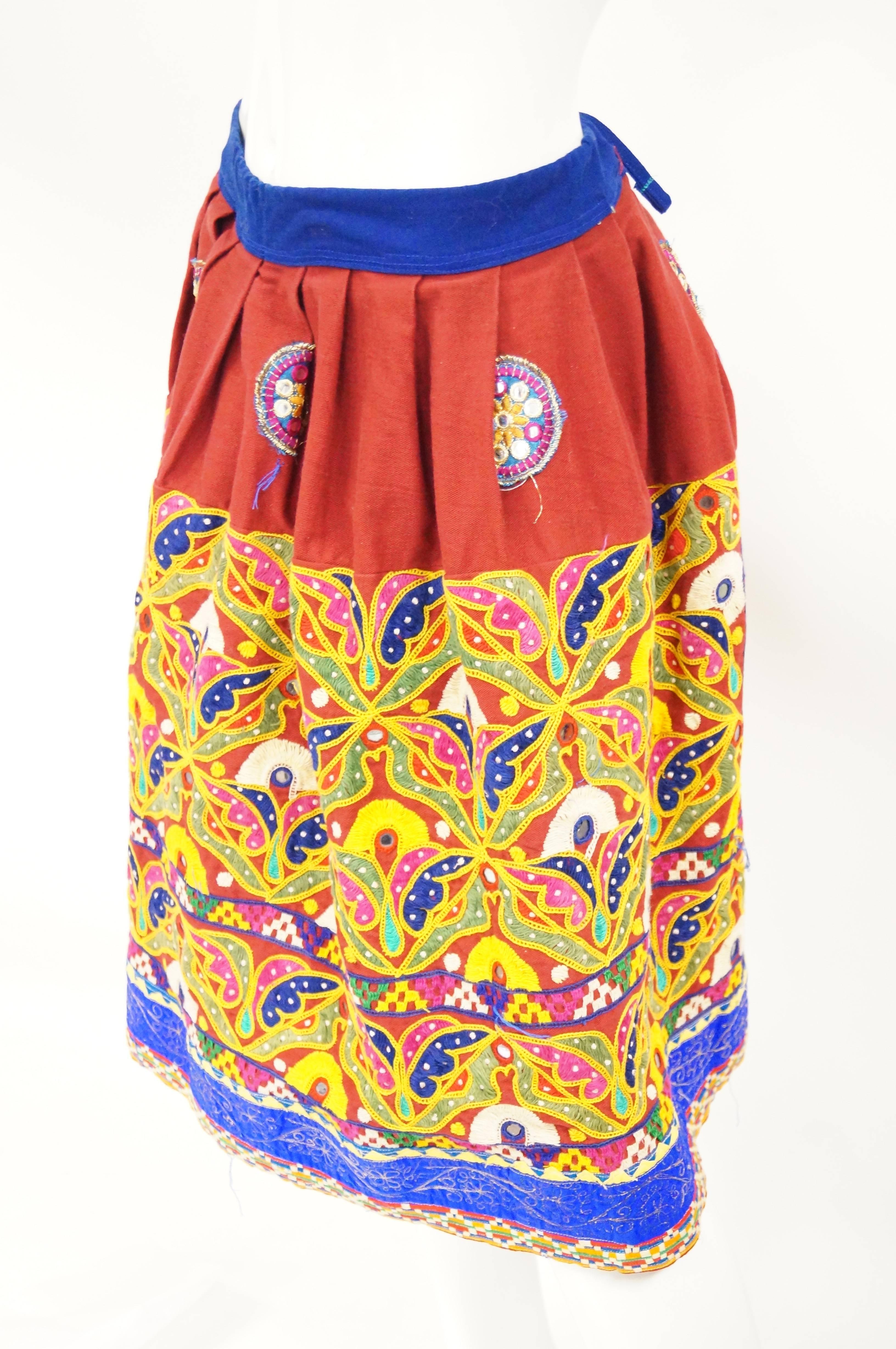 Bright red, yellow, and blue skirt with organic petal-like embroidery. The skirt is voluminous and features mirror work sequins as part of the embroidery.  Dress it up or dress it down!  