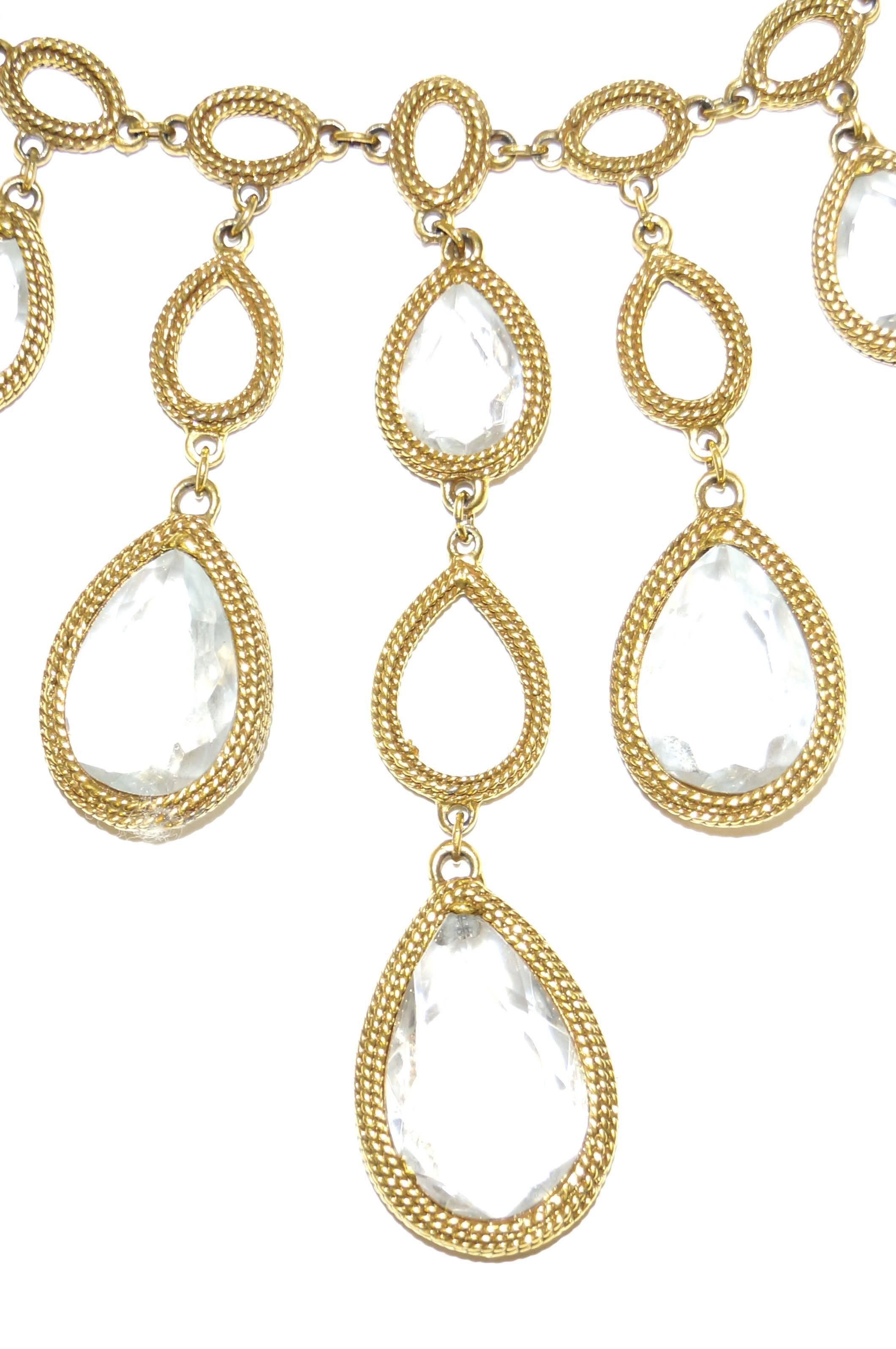 1960s dramatic oversized Goldette glass chandelier drop necklace! The necklace is gold - tone and rope - textured. Necklace features seven hanging strands of graduated lengths, composed of alternating glass chandelier jewels in teardrop frames. The