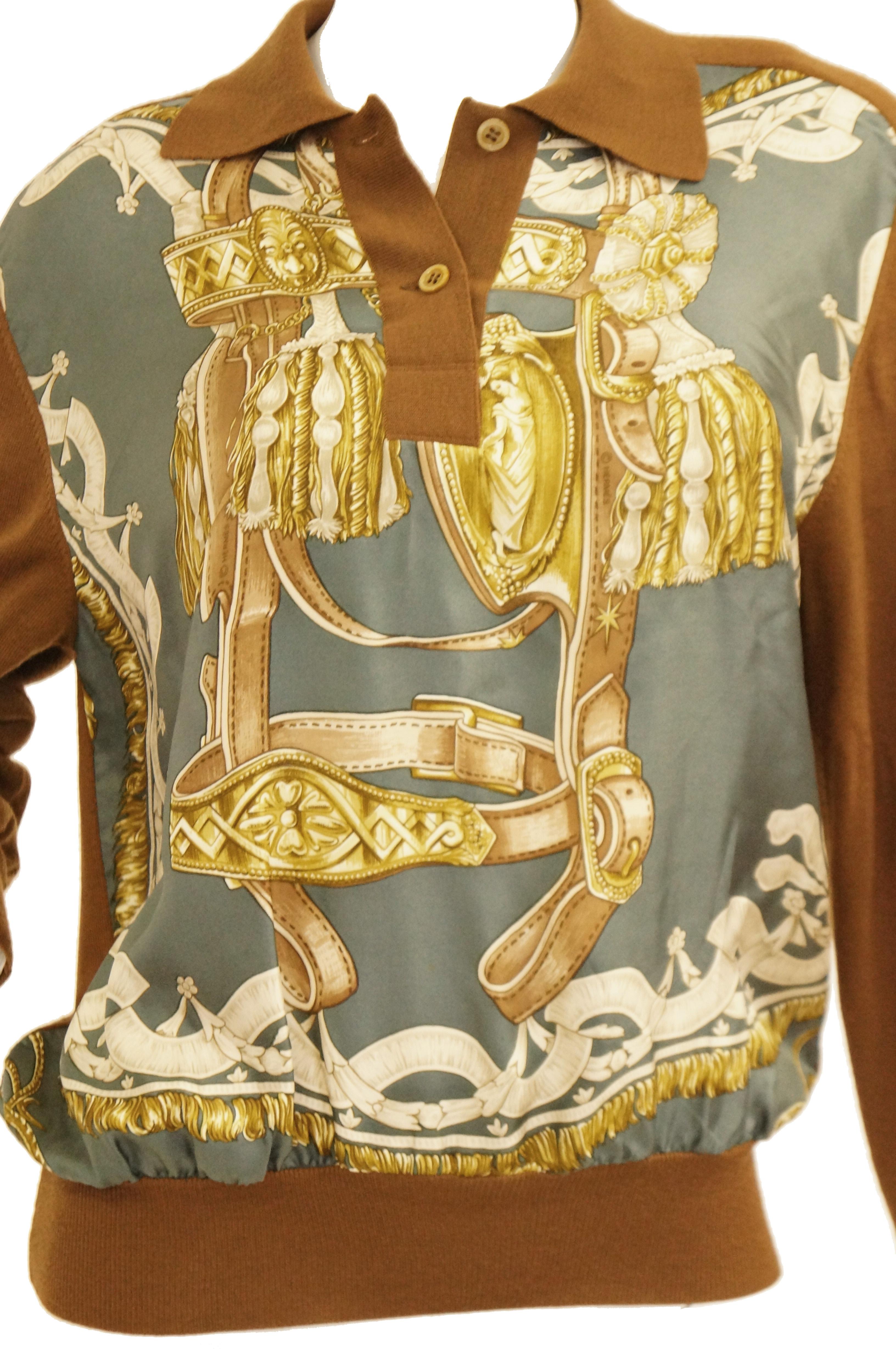 A classic chocolate brown cashmere sweater elevated to sheer sophistication with a silk scarf front.  The equestrian theme is a favorite theme of Hermes, and is expertly achieved with both a relaxed and elegant way; the scarf depicts a brown bridle