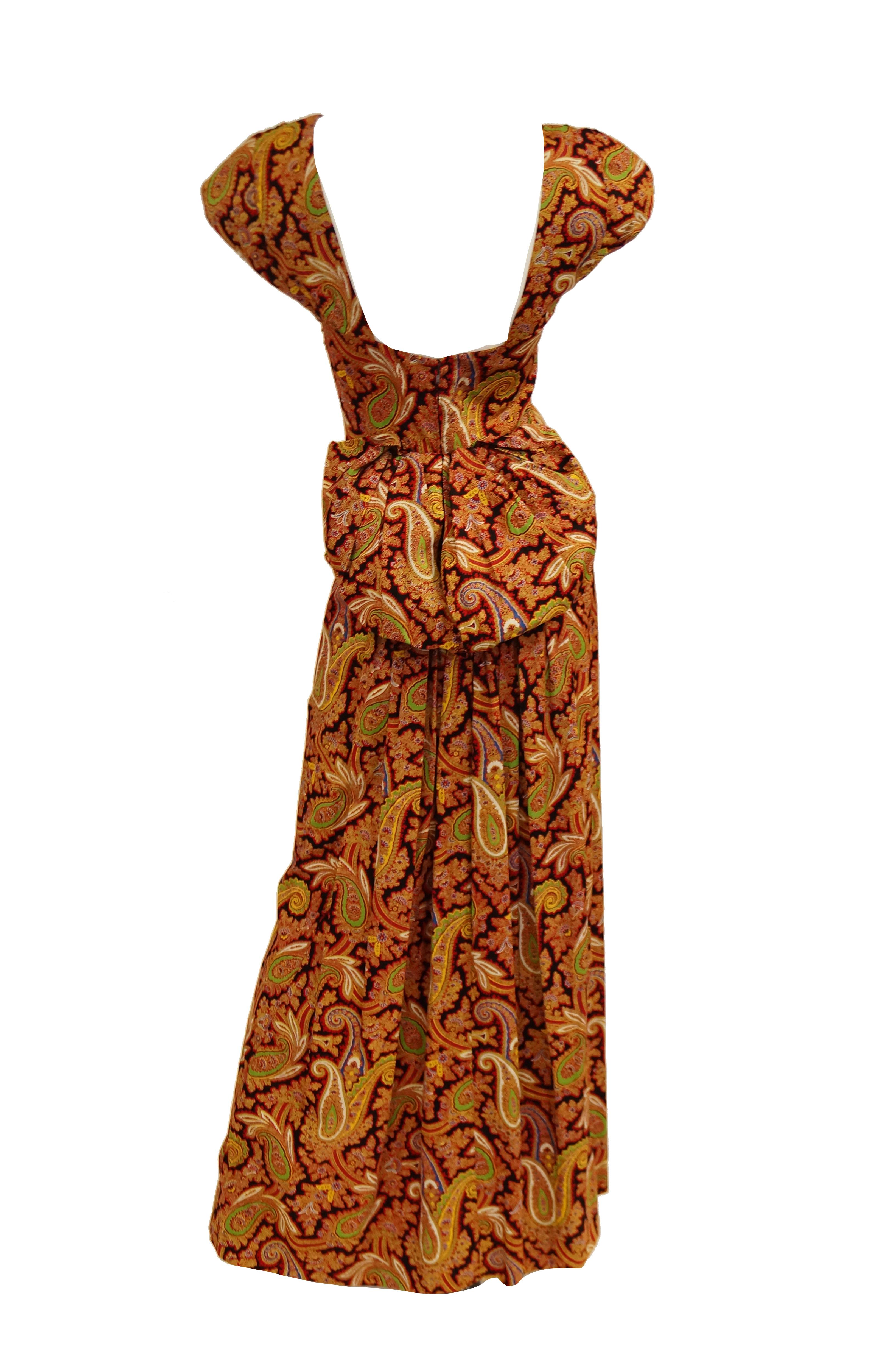 ABSOLUTELY Gorgeous 1940s dress in a lush red and gold paisley floral print! This maxi evening dress features short lightly capped sleeves, a sweetheart neckline with ruched point, a low scoop back, and an amazing bow - like bustle! The skirt is
