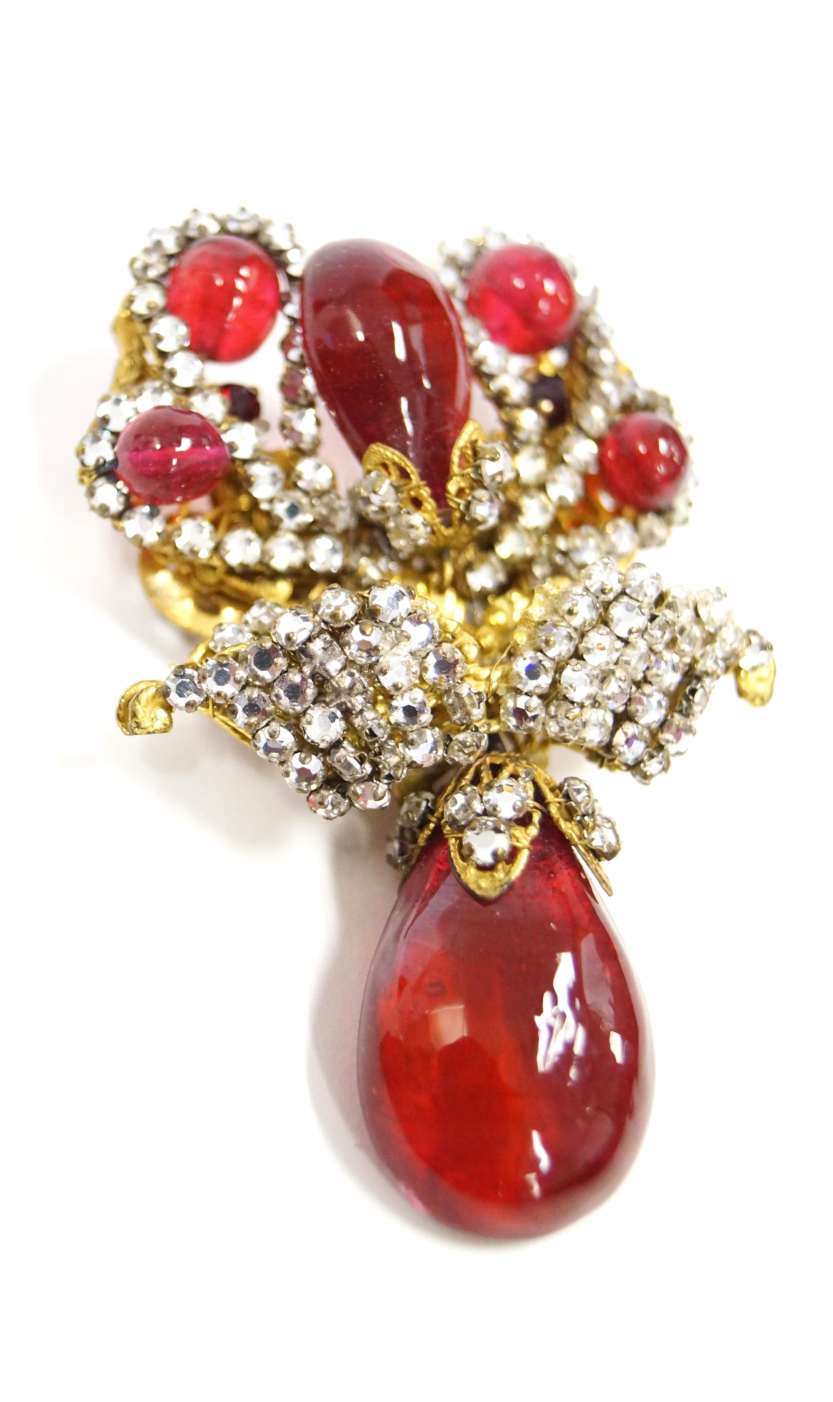 Exquisite ruby poured glass and rhinestone regal brooch all affixed to an antiqued gold filigree setting consisting of three moving parts. Large tear drop bead hangs from a loop allowing motion. All stones are sewn in with gilt wire in the typical