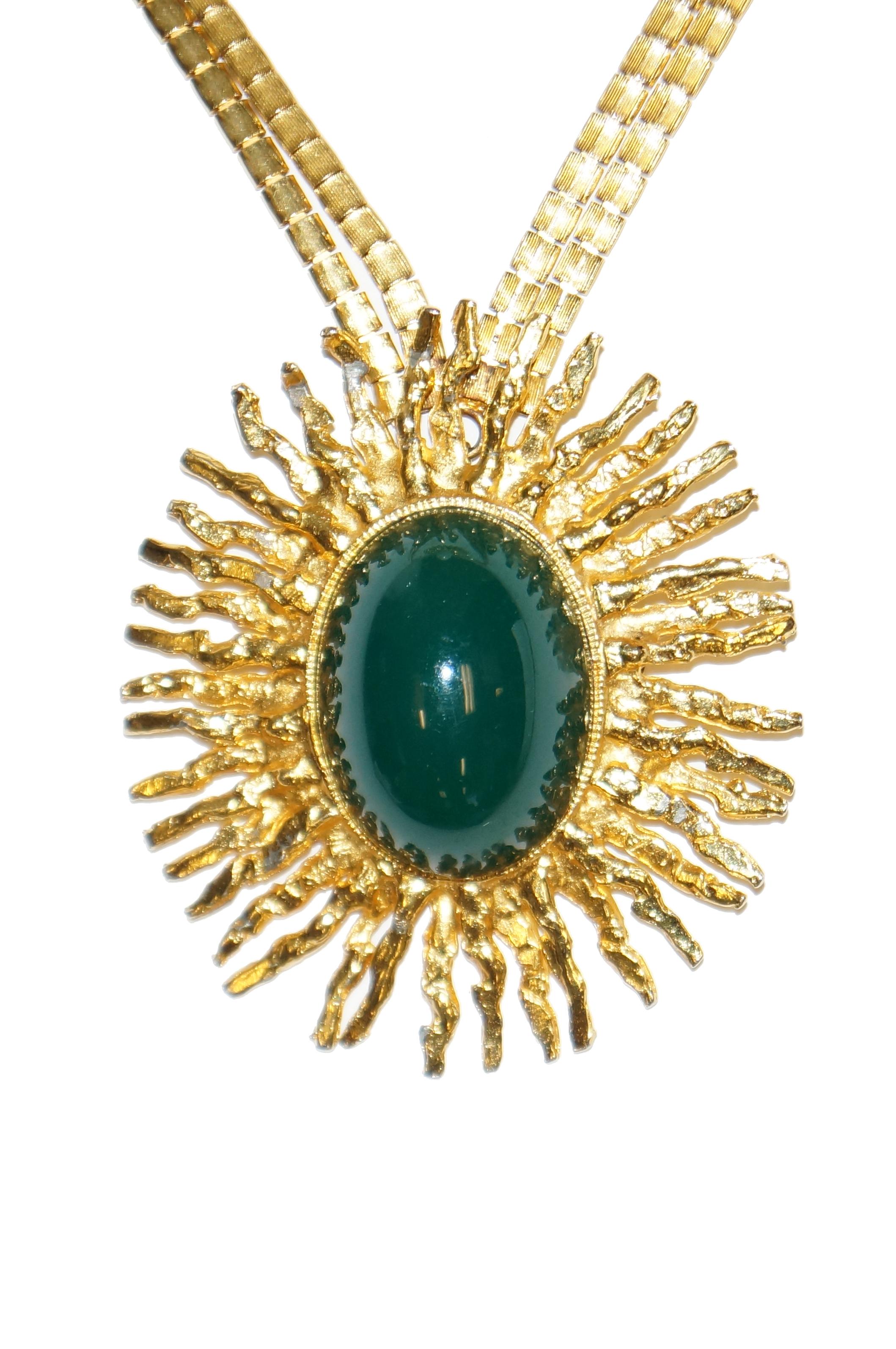 Designed by Robert Levy this 1960s necklace has two interchangeable sun burst pendants; one in green and one in white. The pendants are gold tone with large lucite centers and hammered sun bursts. The double horsetail chain hangs 11 inches but is 21