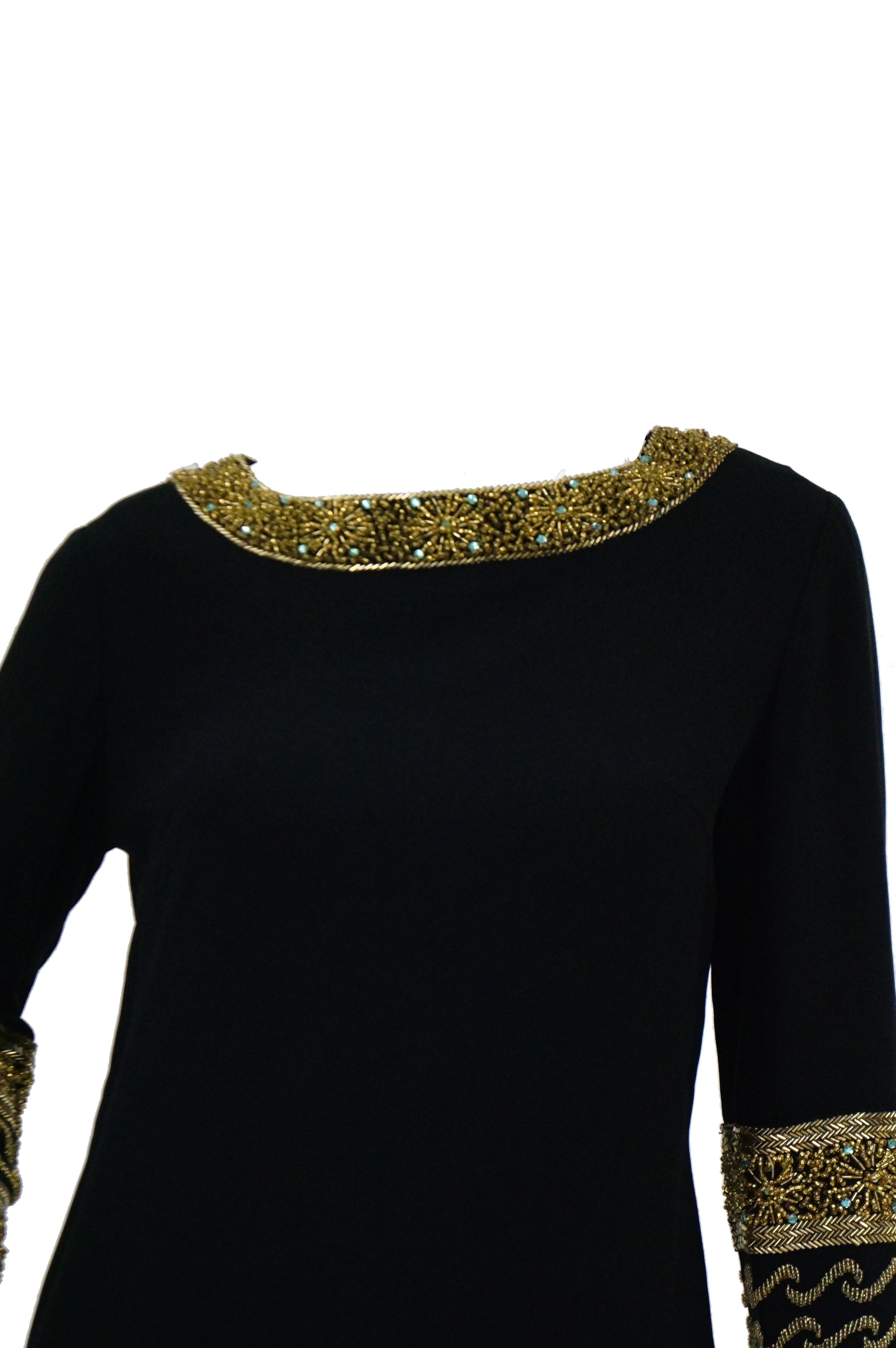 This elegant black silk shift dress features eye - popping neckline and cuff details! This long sleeve dress falls at around the knee and has a wide jewel collar that is absolutely bedecked with gold seed and bugle beads! The beads are arranged in a
