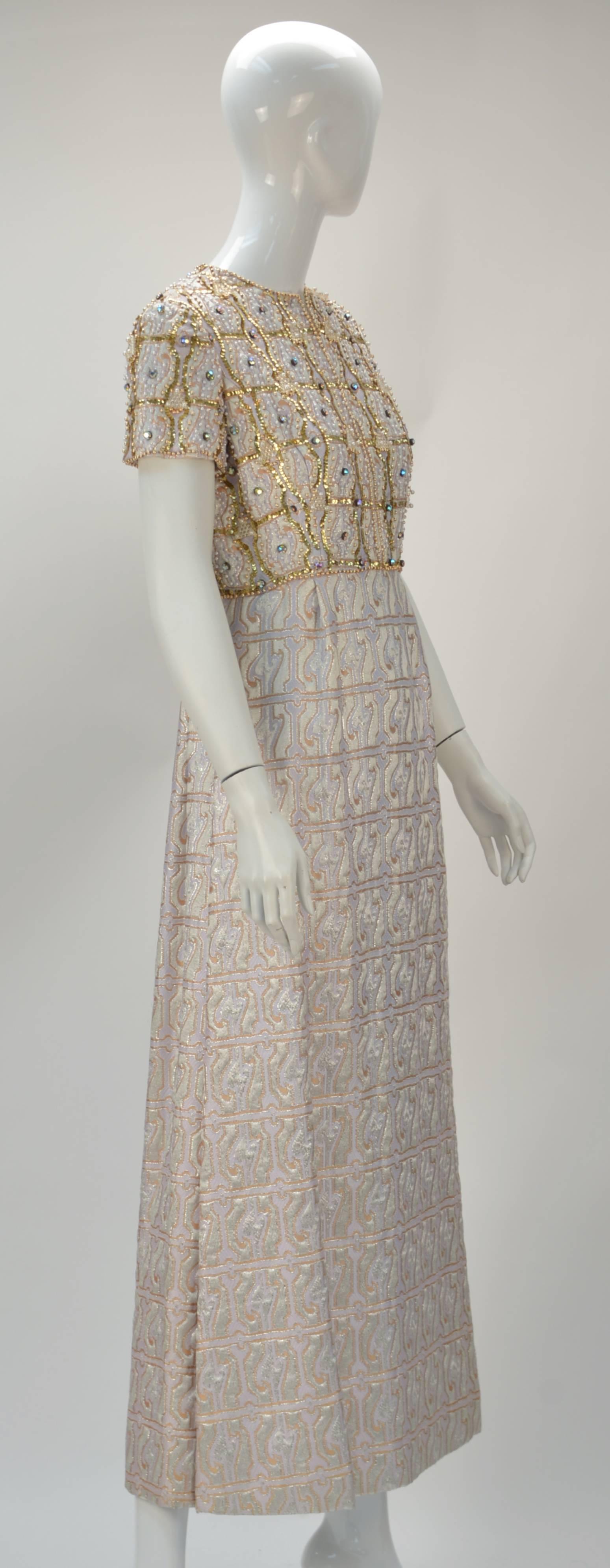 Graceful 1960's Gino Charles multi color with metallic gold brocade evening dress with sequins and beading. The label reads: 