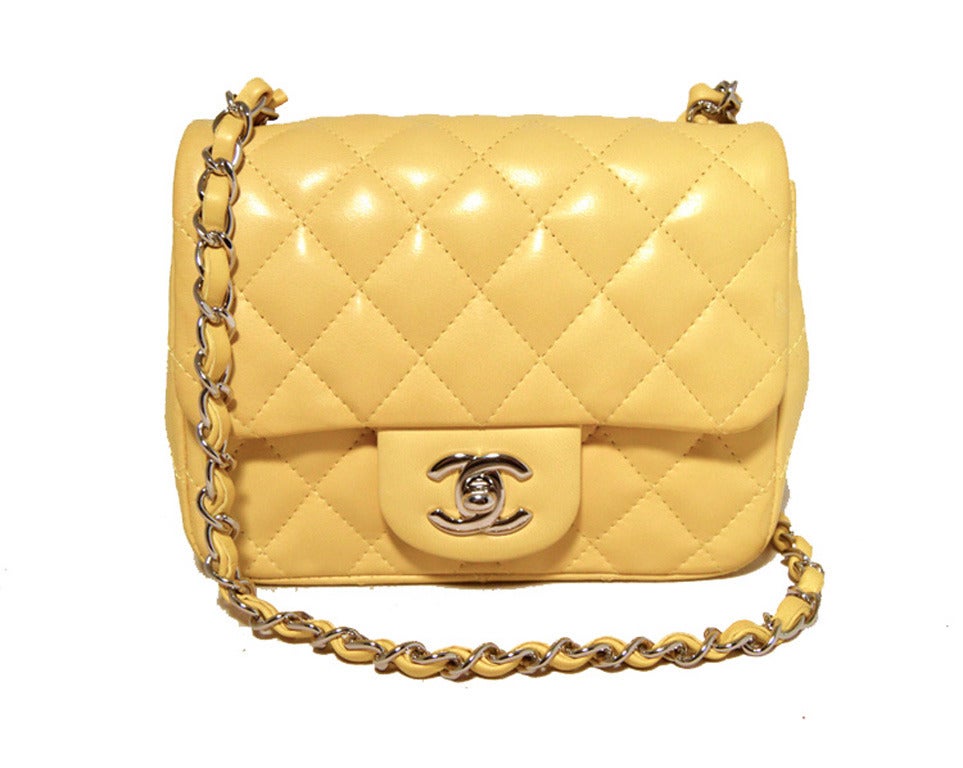 FABULOUS CHANEL yellow mini classic flap shoulder bag in excellent condition.  Supple yellow quilted lambskin leather exterior trimmed with shining silver hardware and woven chain and leather shoulder strap.  Signature CC twist closure opens single