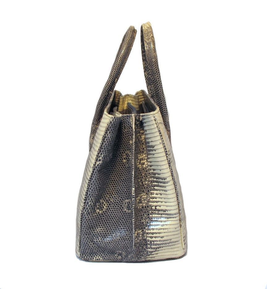 This stunning Alexandra Knight handbag is in mint condition.  The exterior features gorgeous exotic ring lizard skin and is in pristine condition.  The interior is fully lined in grey suede and features two separate storage compartments to help keep